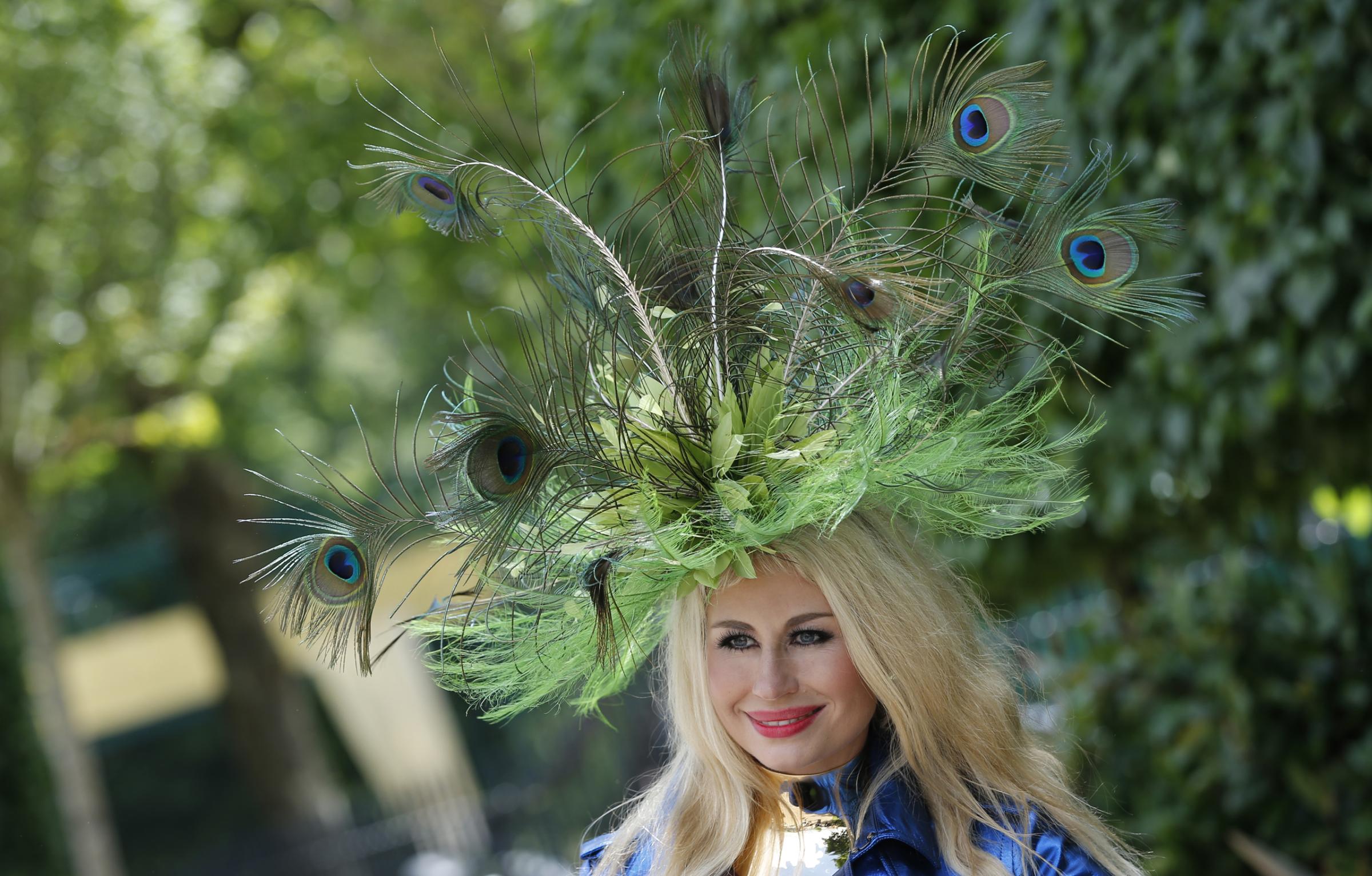A woman wears an ornate hat made from peacock feathers on the second day of the Royal Ascot horse race meeting at Ascot, England, Wednesday, June 15, 2016. (AP Photo/Alastair Grant)
