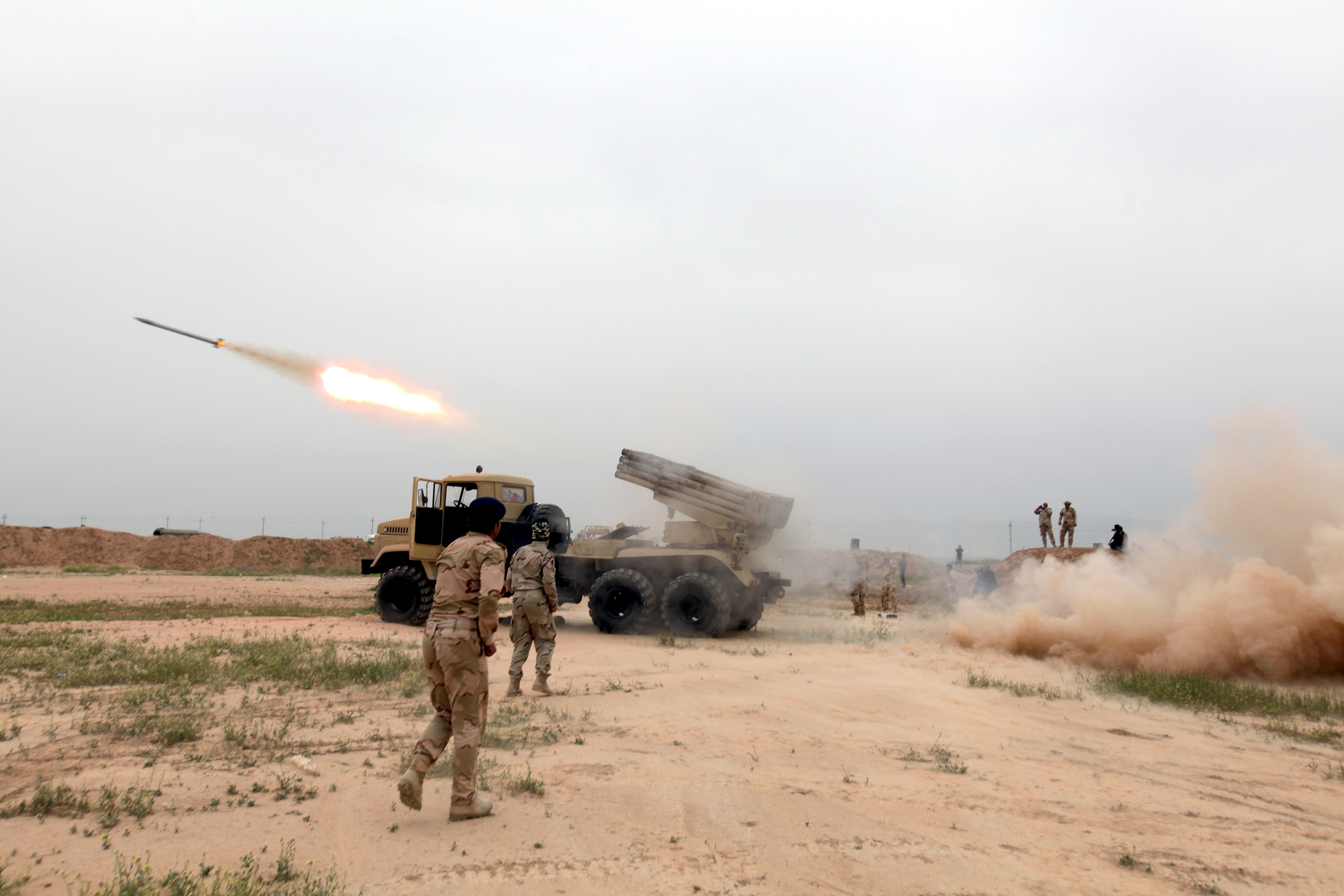 Iraqi soldiers fire a rocket toward Islamic State militants on the outskirt of the Makhmour south of Mosul