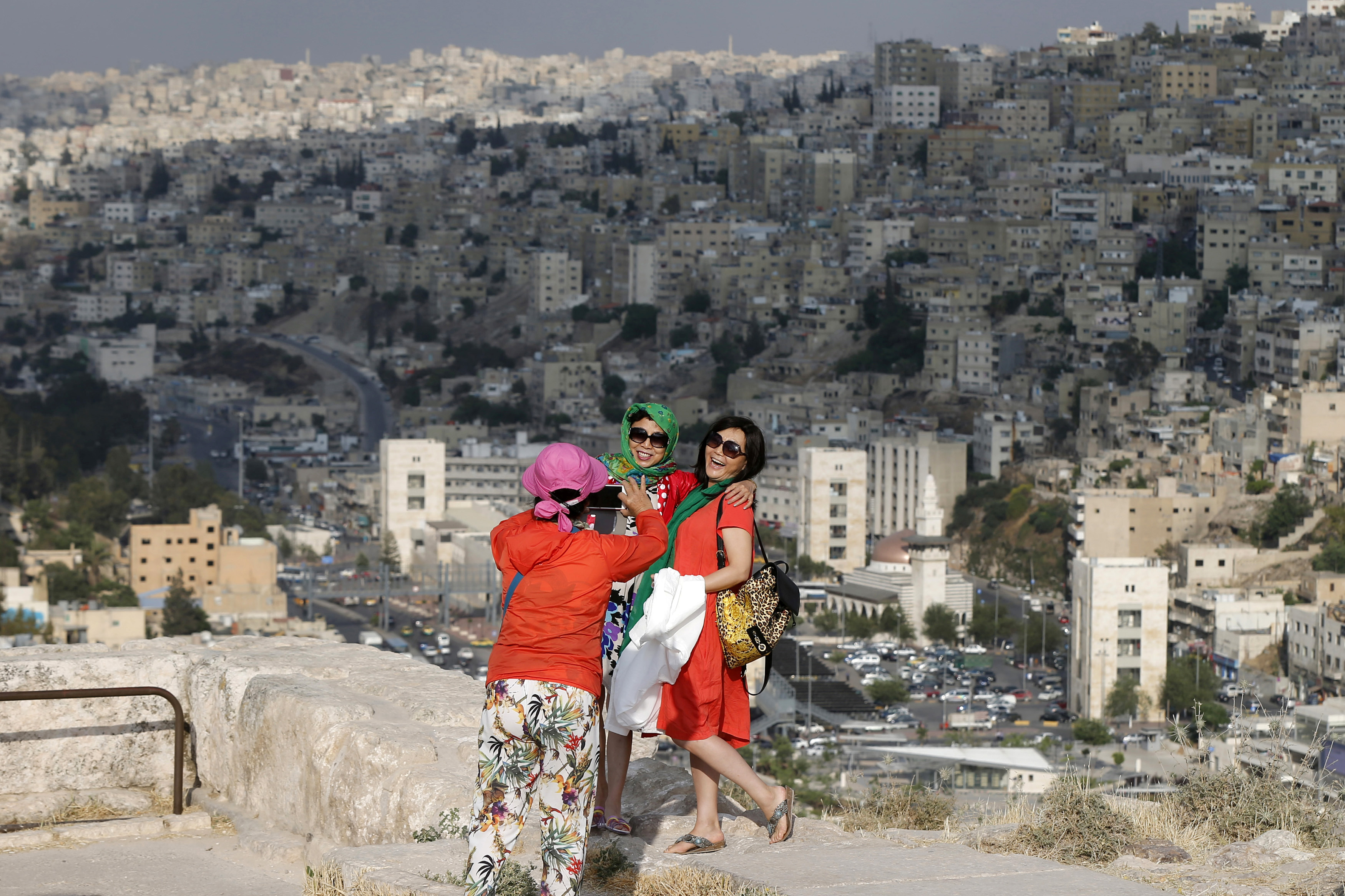 Chinese tourists take pictures during their visit to the Amman Citadel, an ancient Roman landmark in Amman