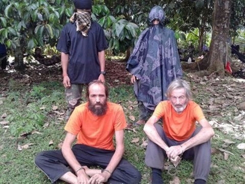 Hostages Canadian national Robert Hall and Norwegian national Kjartan Sekkingstad are seen in this undated picture released to local media, in Jolo