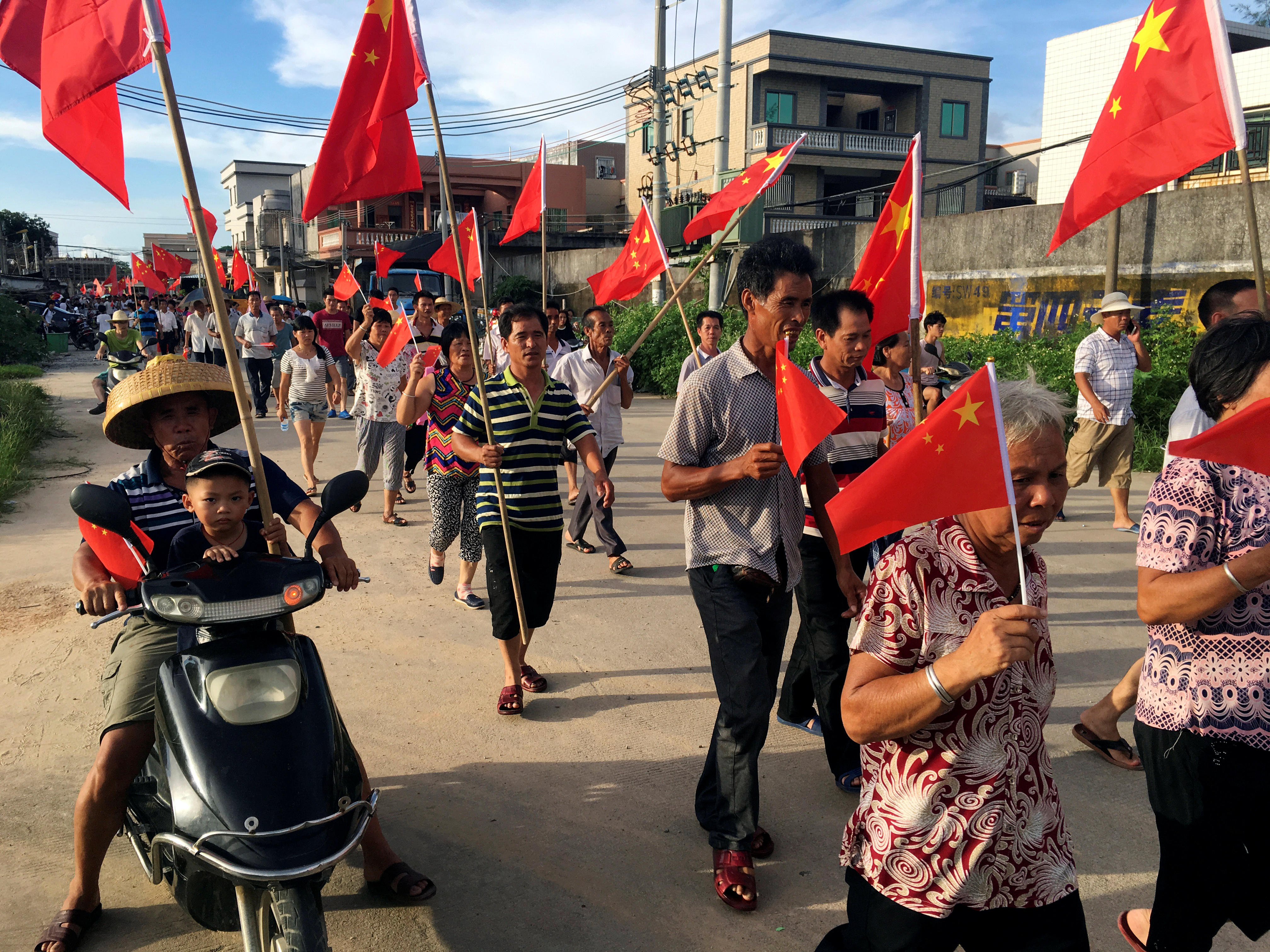 Villagers carrying Chinese national flags protest at Wukan village in China's Guangdong province