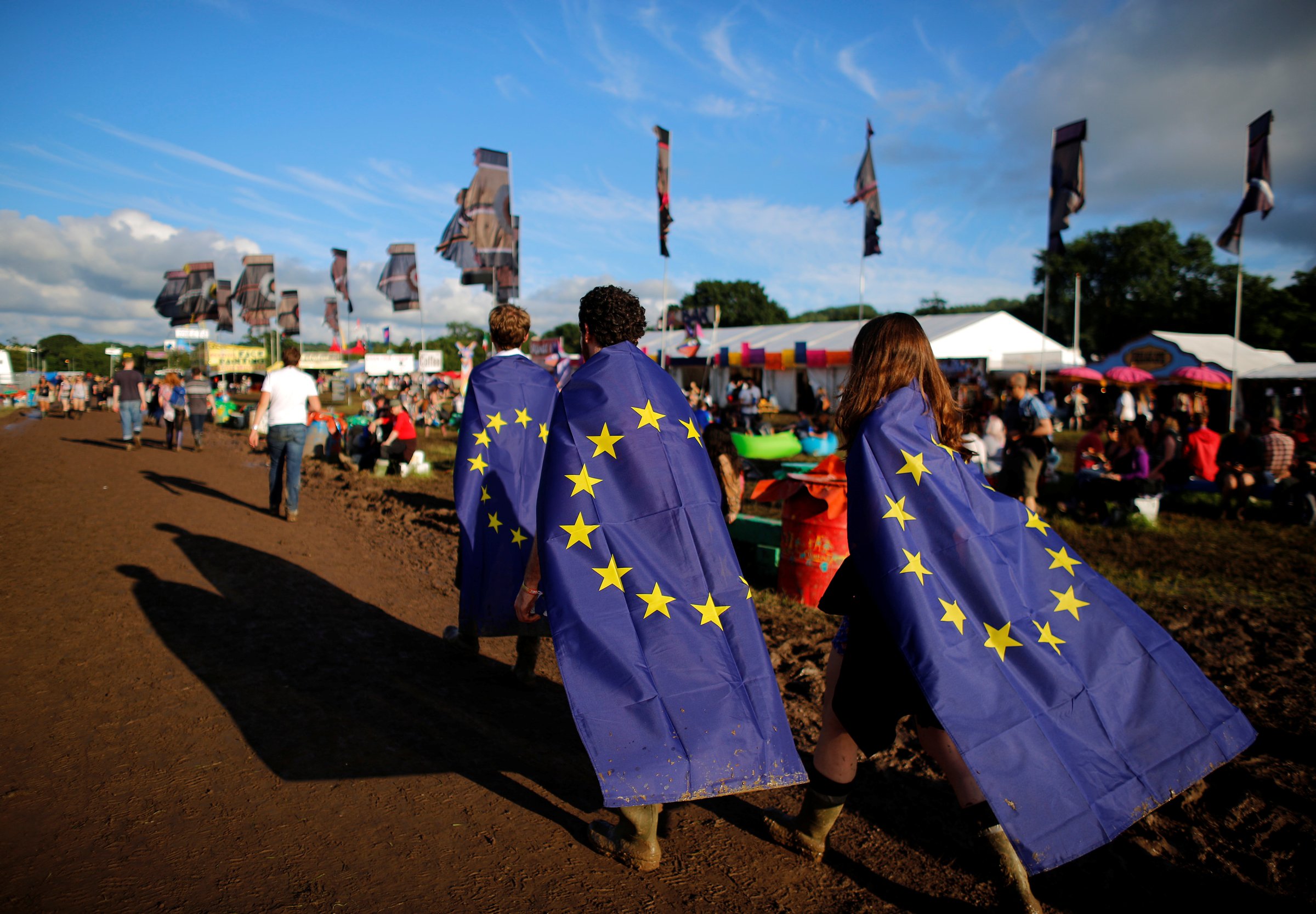 Revellers wrapped in European Union flags walk at Worthy Farm in Somerset during the Glastonbury Festival