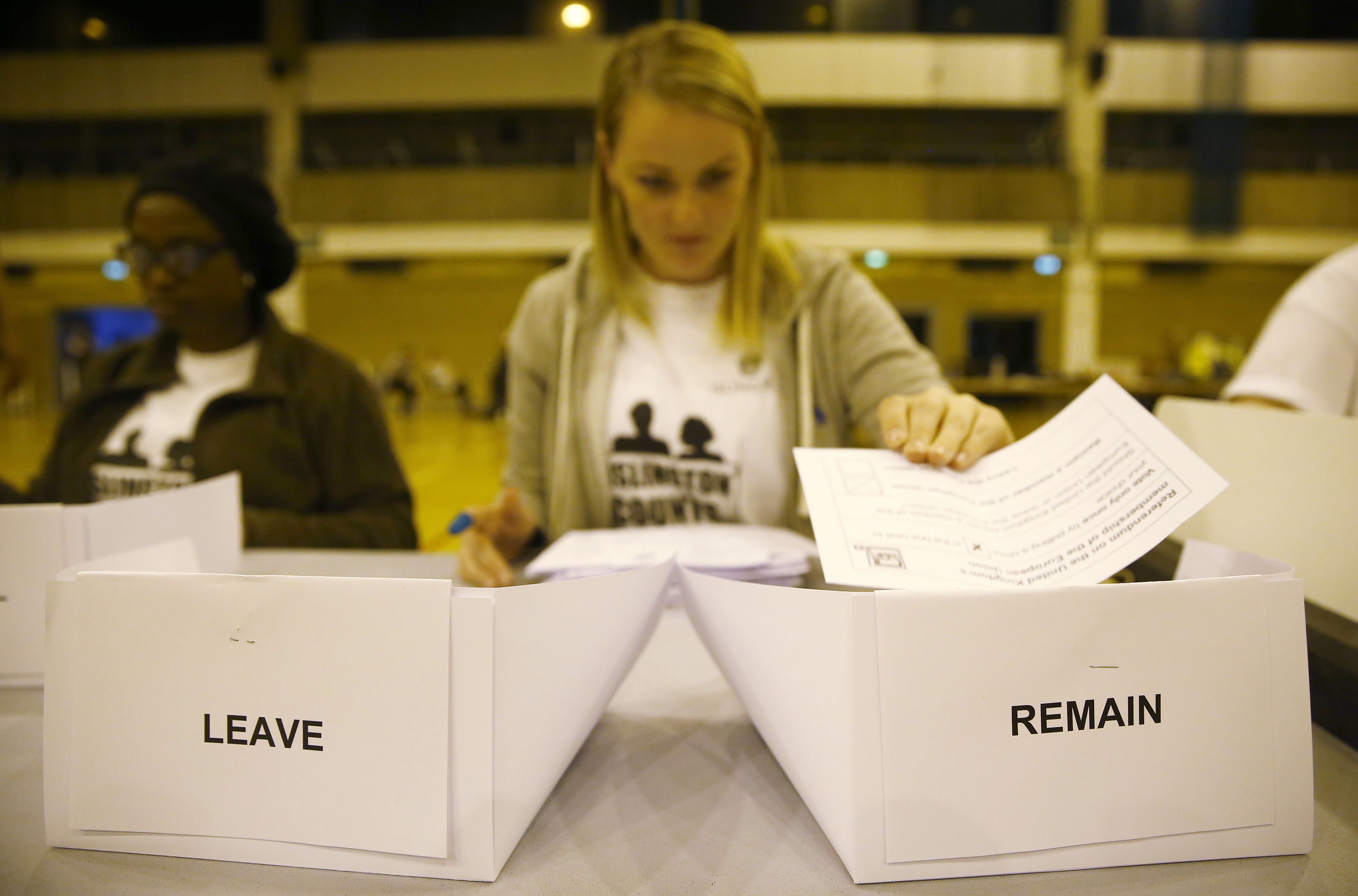 A workers counts ballots after polling stations closed in the Referendum on the European Union in Islington, London