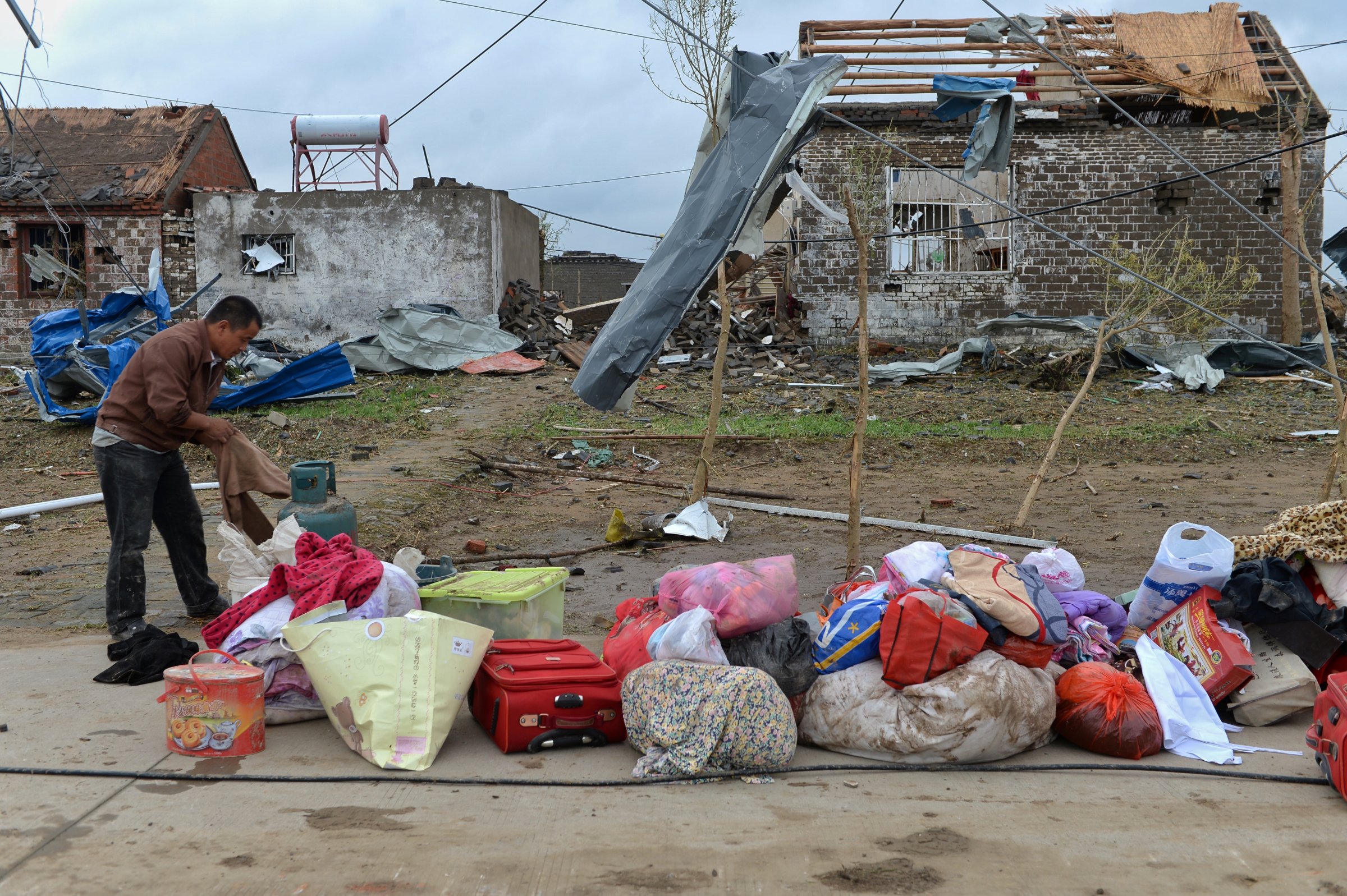 A men takes out his belongings from his damaged house after a tornado hit Funing on Thursday, in Yancheng