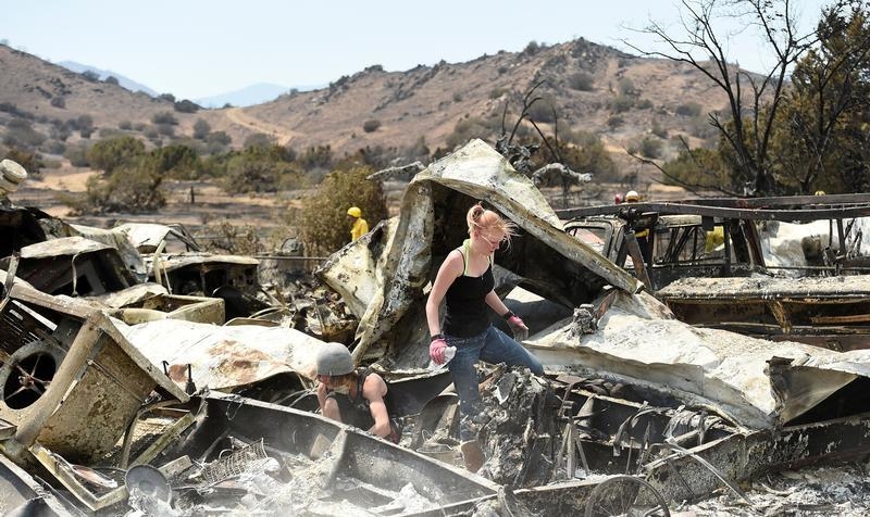 Emily Fryer, 20, searches for family heirlooms at her boyfriend's leveled home after the Erskine Fire burned through South Lake, California, U.S. June 26, 2016 (Noah Berger—Reuters)