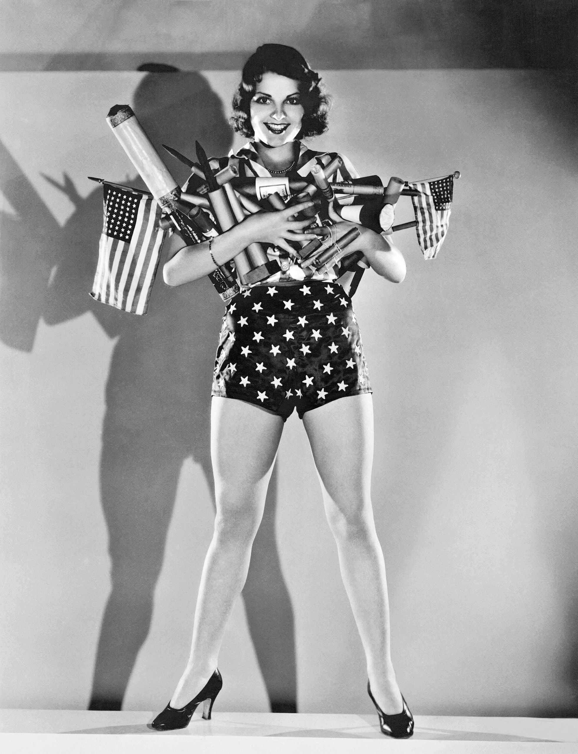 MGM actress Lillian Bond with an armload of fireworks for a Fourth of July celebration, Hollywood, California, circa 1930.