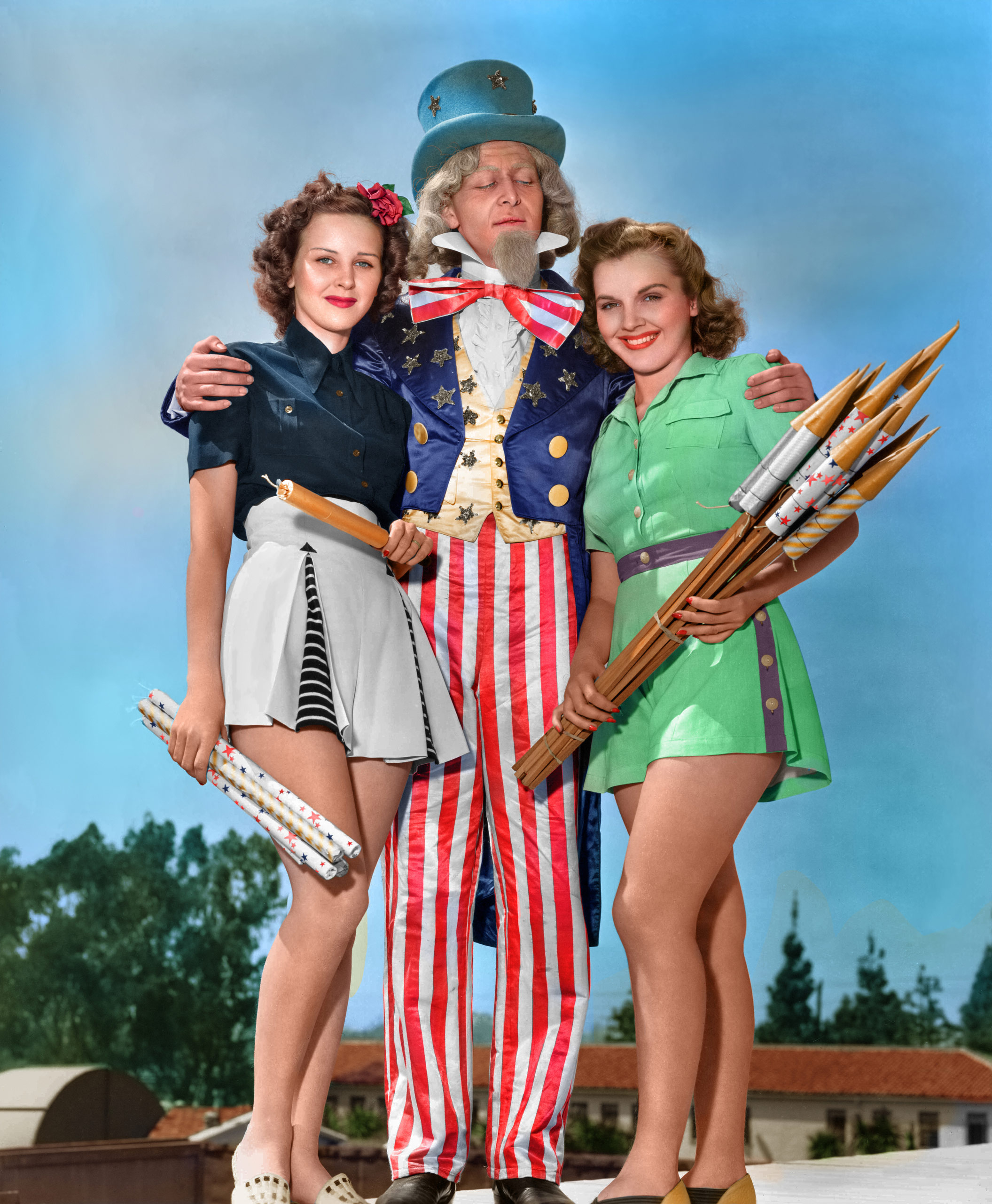 Costumed actors promote 4th of July celebrations as they pose with fireworks, Chicago, Illinois, circa 1940.