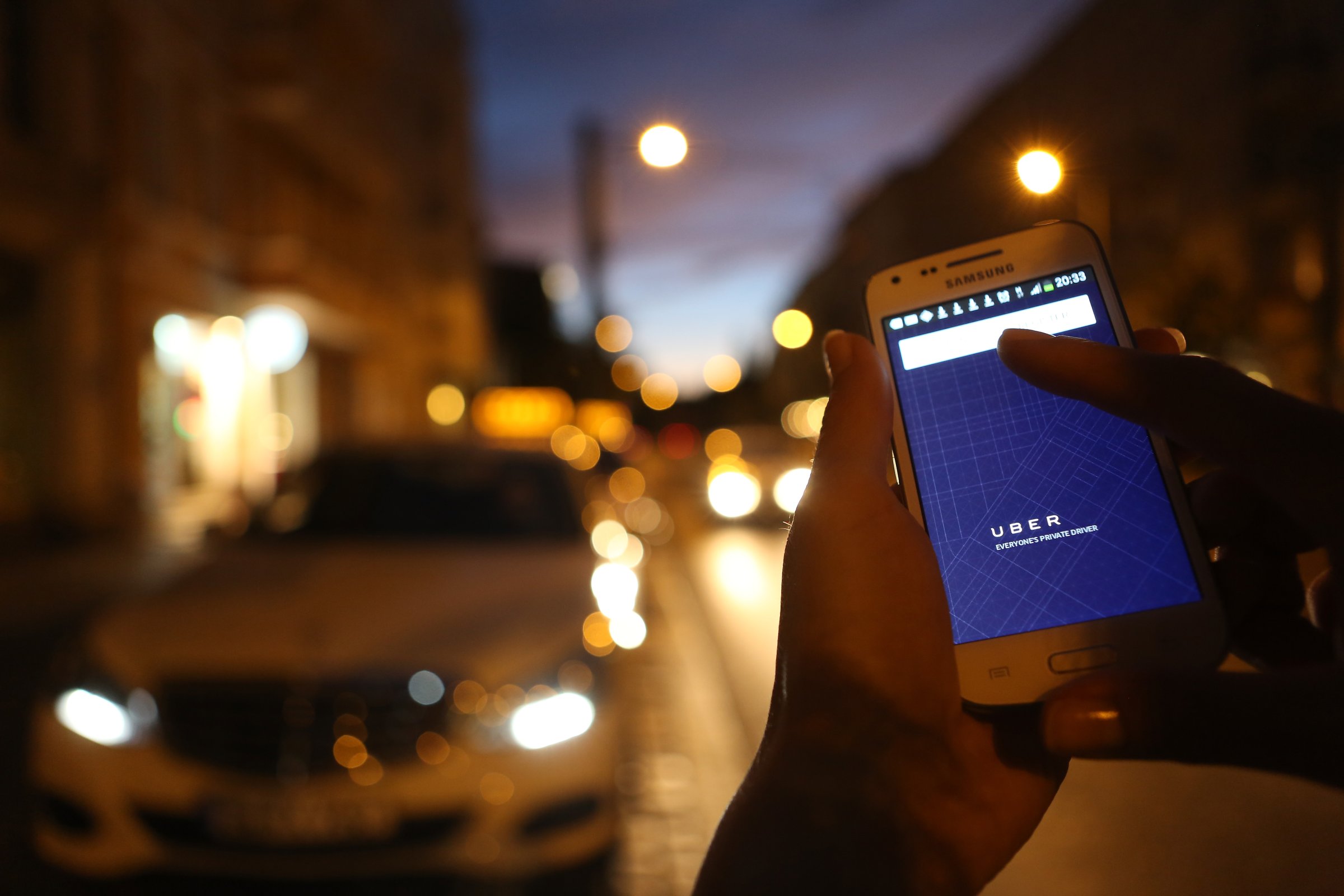 In this photo illustration, a woman uses the Uber app on an Samsung smartphone on September 2, 2014 in Berlin, Germany.