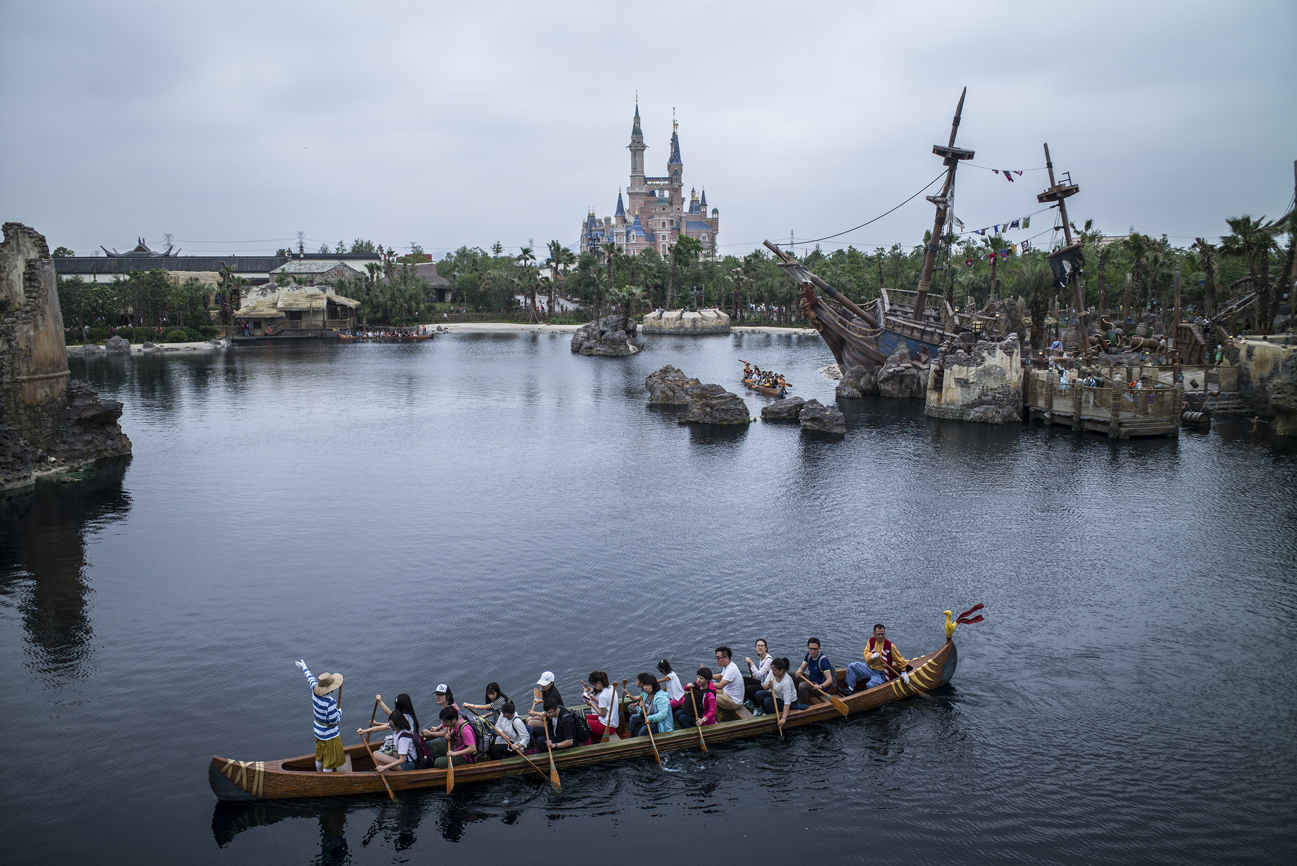 Visitors take the canoe ride at Treasure Cove during a preview of Shanghai Disneyland on June 10, 2016, in Shanghai (Lam Yik Fei—The New York Times/Redux)