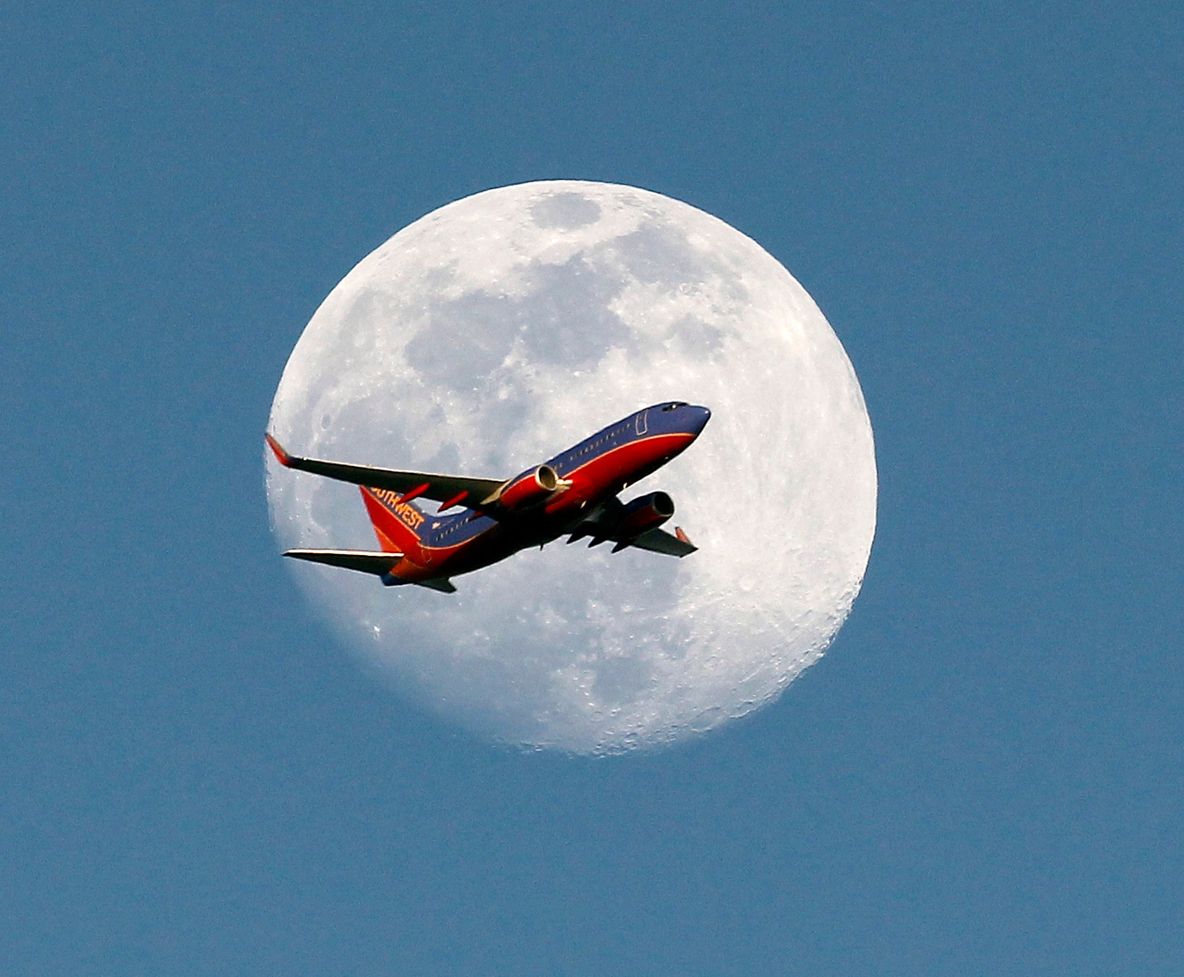 Plane crosses moon