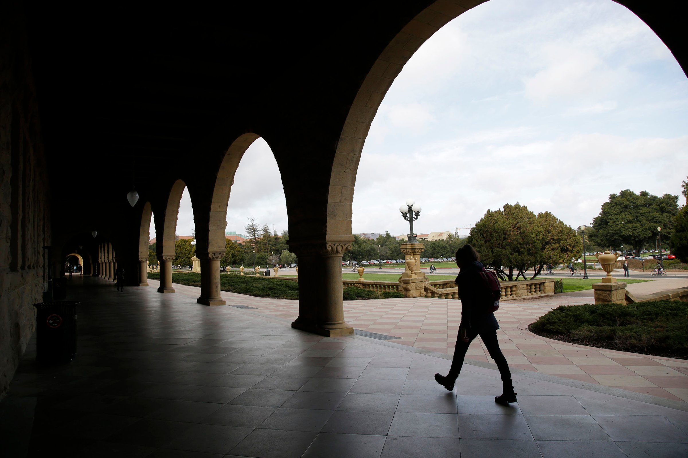 A student walks on campus at Stanford University in Calif., Jan. 13, 2016,
