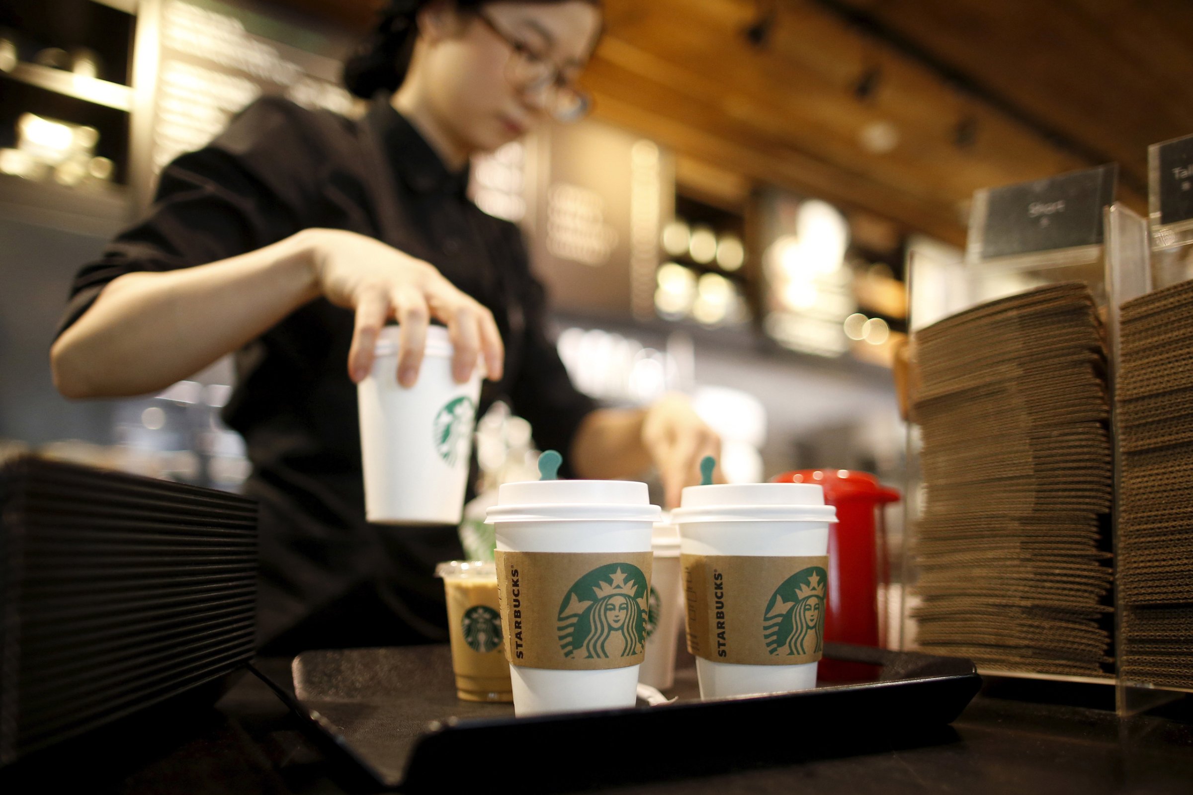 A staff serves beverages at a Starbucks coffee shop in Seoul, South Korea, March 7, 2016. Picture taken March 7, 2016. REUTERS/Kim Hong-Ji - RTSDL07