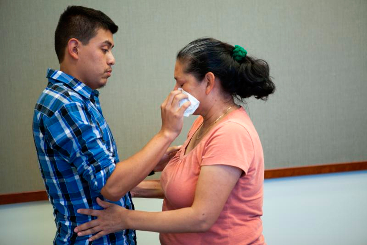 Steve Hernandez wipes a tear from his mother's eye after seeing her for the first time in 20 years in San Diego, Calif., on June 9, 2016. (Christopher Lee—San Bernardino County District Attorney's Office/AP)