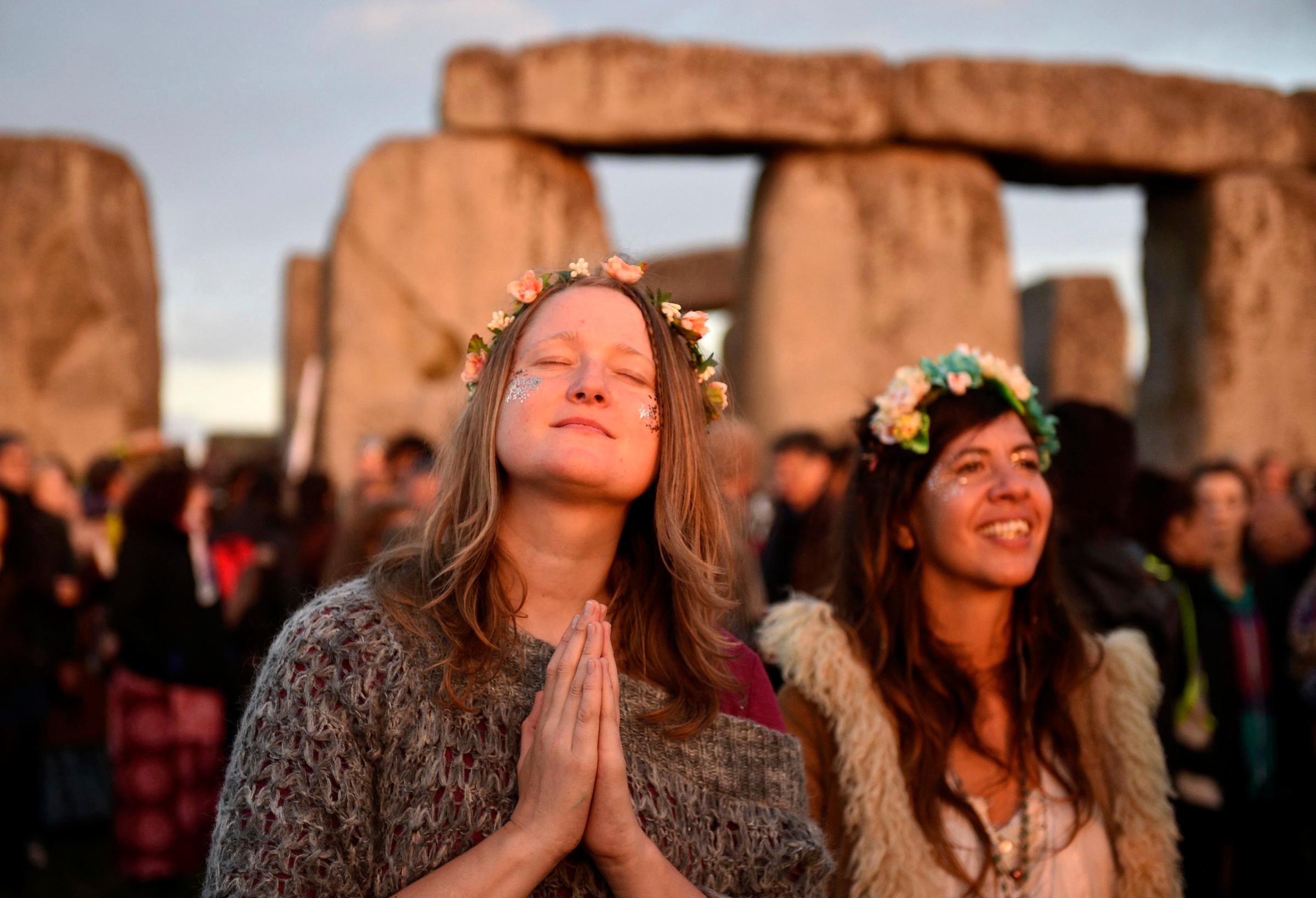 People gather to see the sun rise at the ancient stone circle Stonehenge, during the Summer Solstice, the longest day of the year, in Wiltshire, United Kingdom, June 21, 2016.