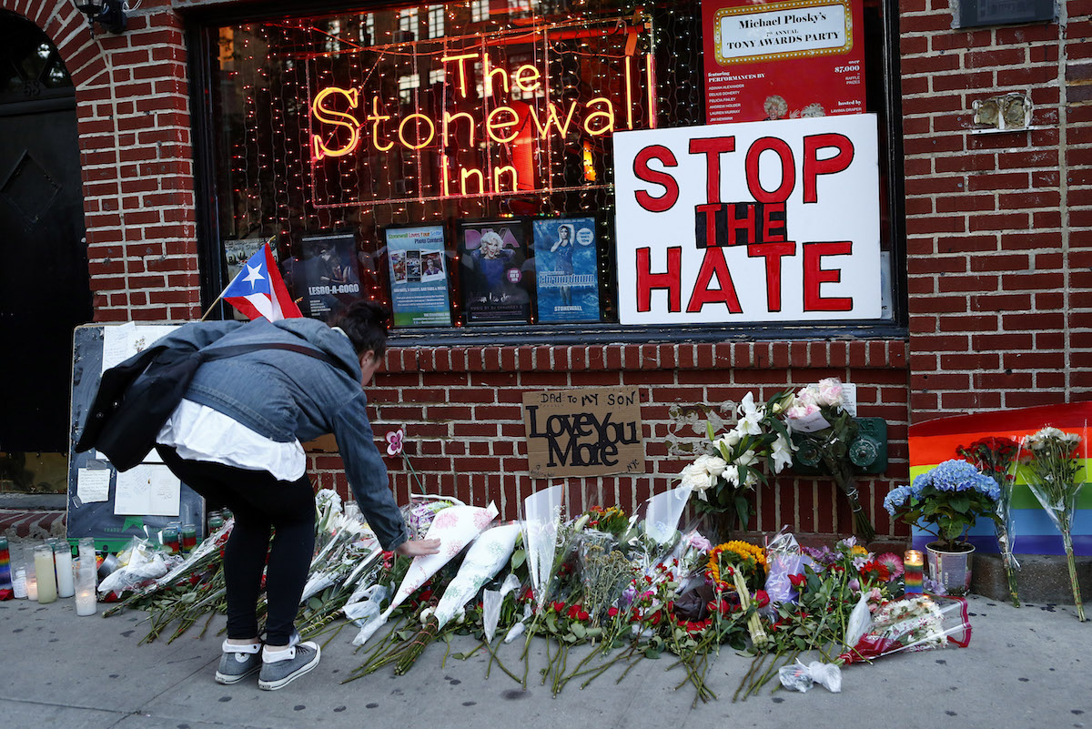 Flowers are placed at a make-shift memorial in front of the Stonewall Inn in New York City, where a vigil was held following the massacre that occurred at a gay Orlando nightclub on June 12, 2016 (Monika Graff—Getty Images)