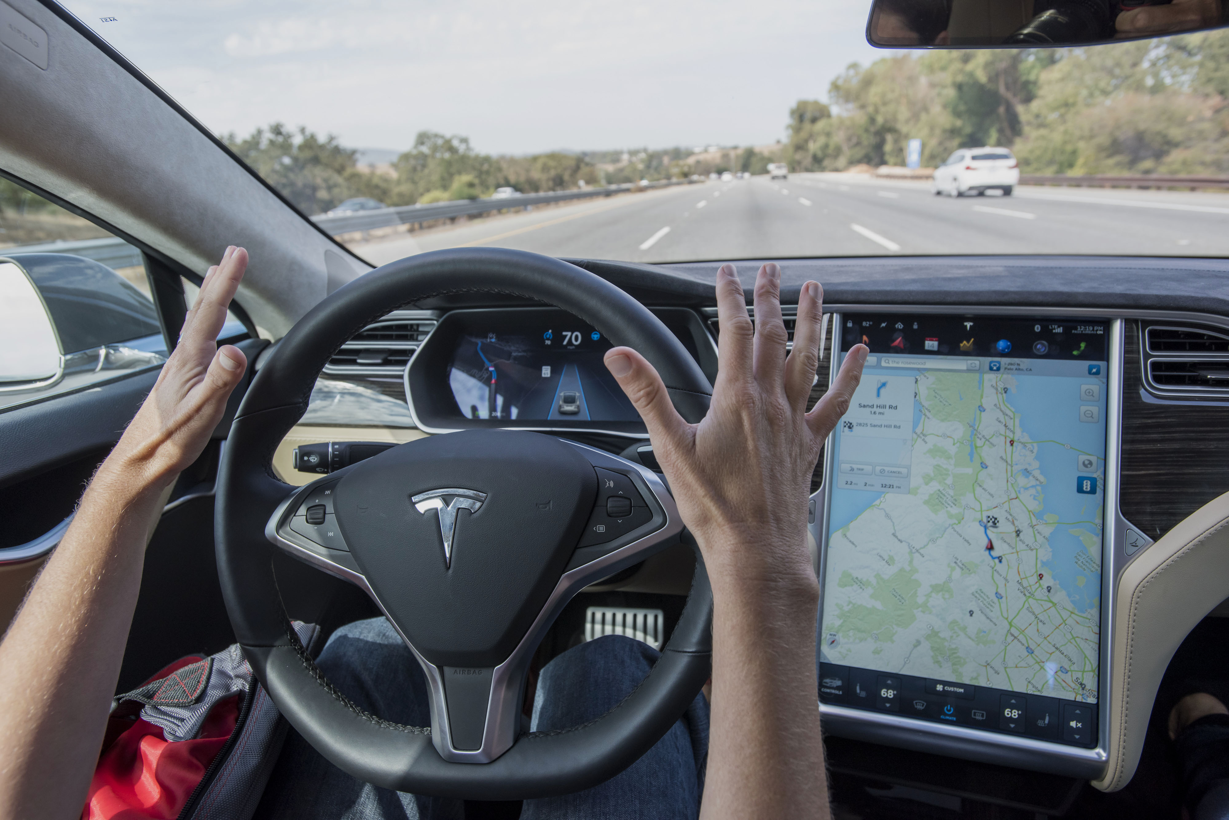 A member of the media test drives a Tesla Motors Inc. Model S car equipped with Autopilot in Palo Alto, Oct. 14, 2015. (David Paul Morris—Bloomberg/Getty Images)