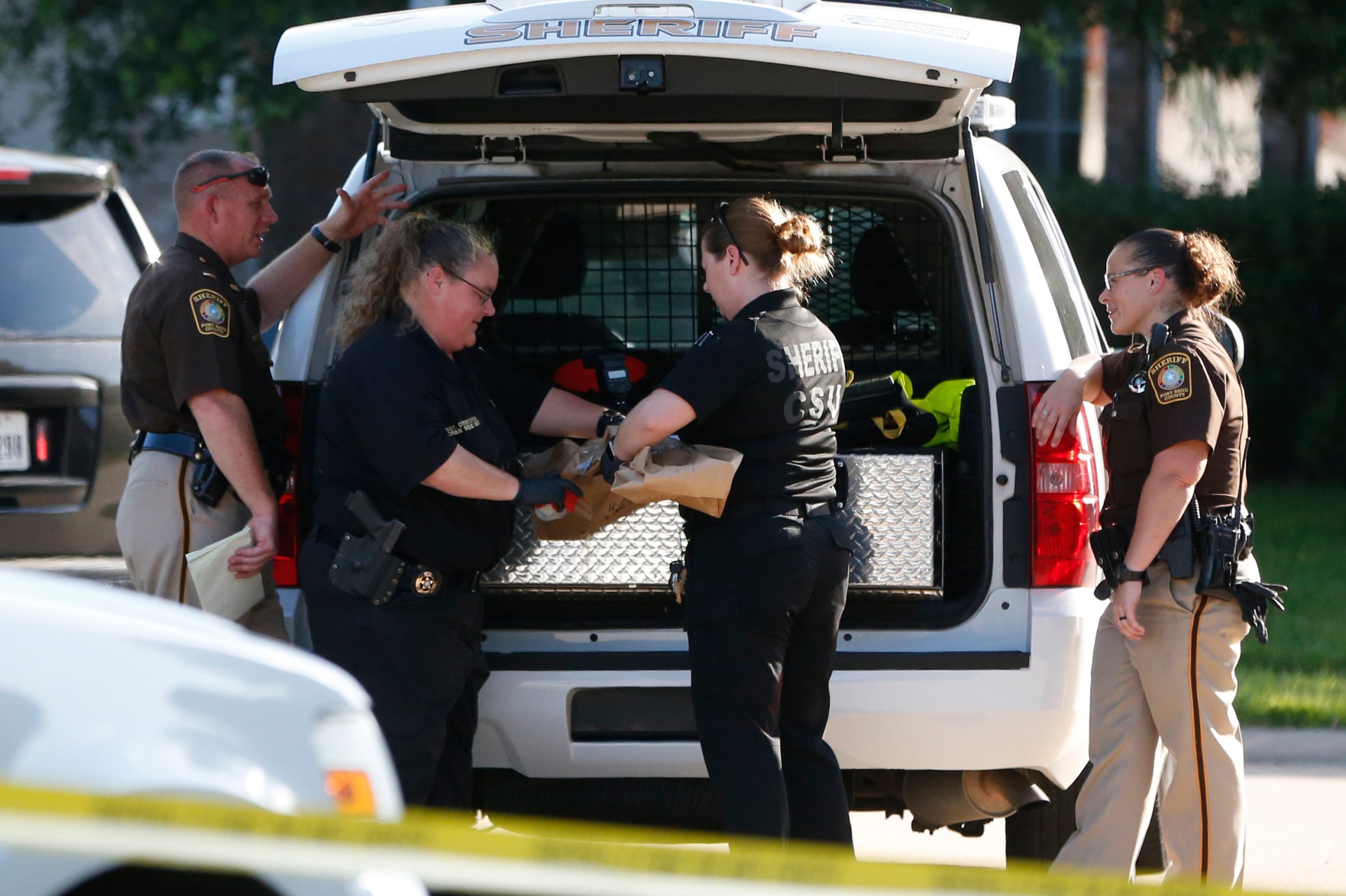 Fort Bend County Sheriffs department crime scene members bag a gun for evidence in a shooting at Blanchard Grove and Remson Hollow in Katy, Texas on June 24, 2016.