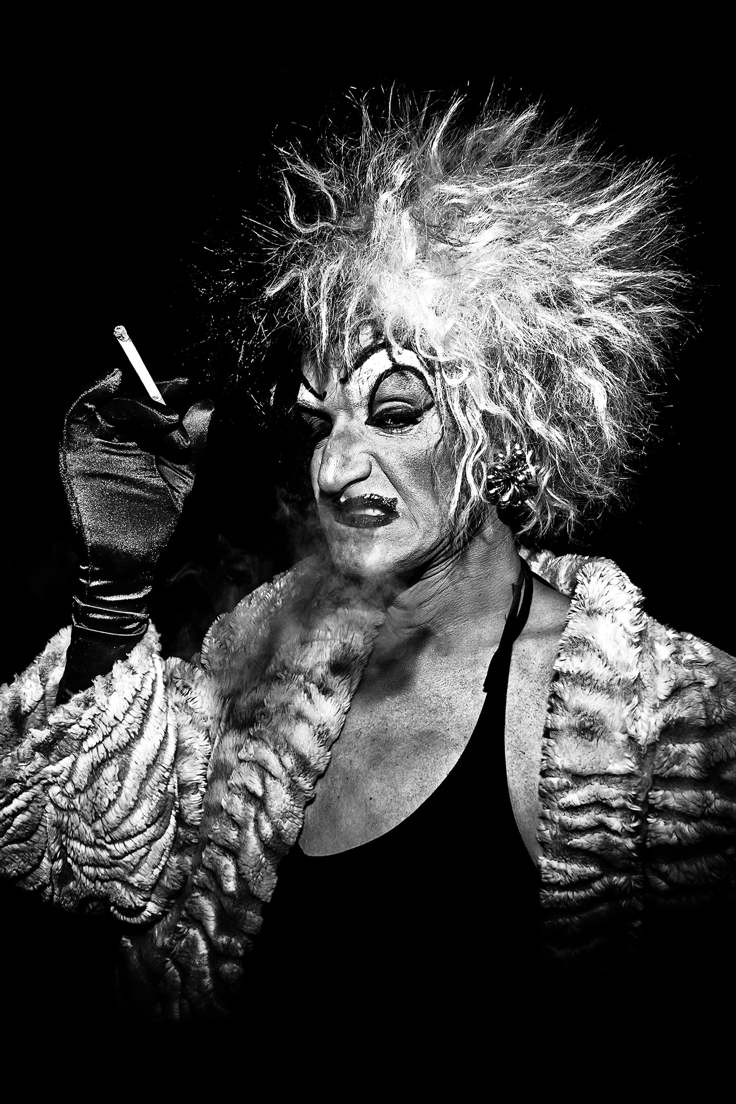 Local legend Mark "Mom" Finley drags on a cigarette while dressed as Cruella de Vil outside Baltic Room on February 24th, 2012, in Seattle.
