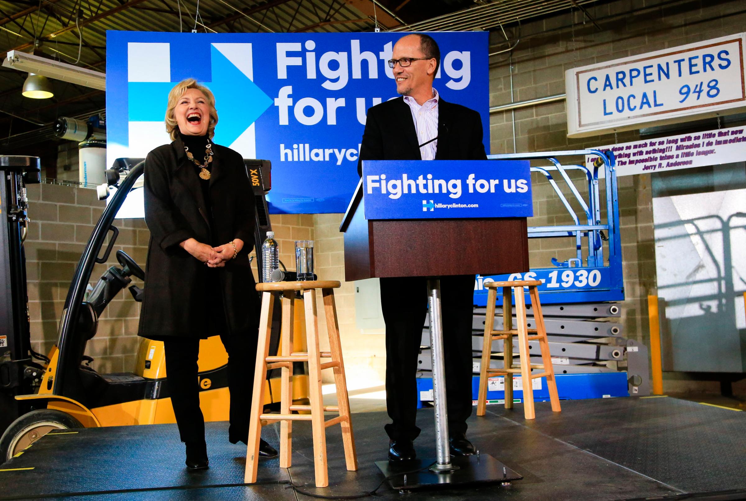 Democratic presidential candidate Hillary Clinton laughs as U.S. Secretary of Labor Tom Perez endorses her during a campaign stop in Sioux City, Iowa, on Dec. 4, 2015.