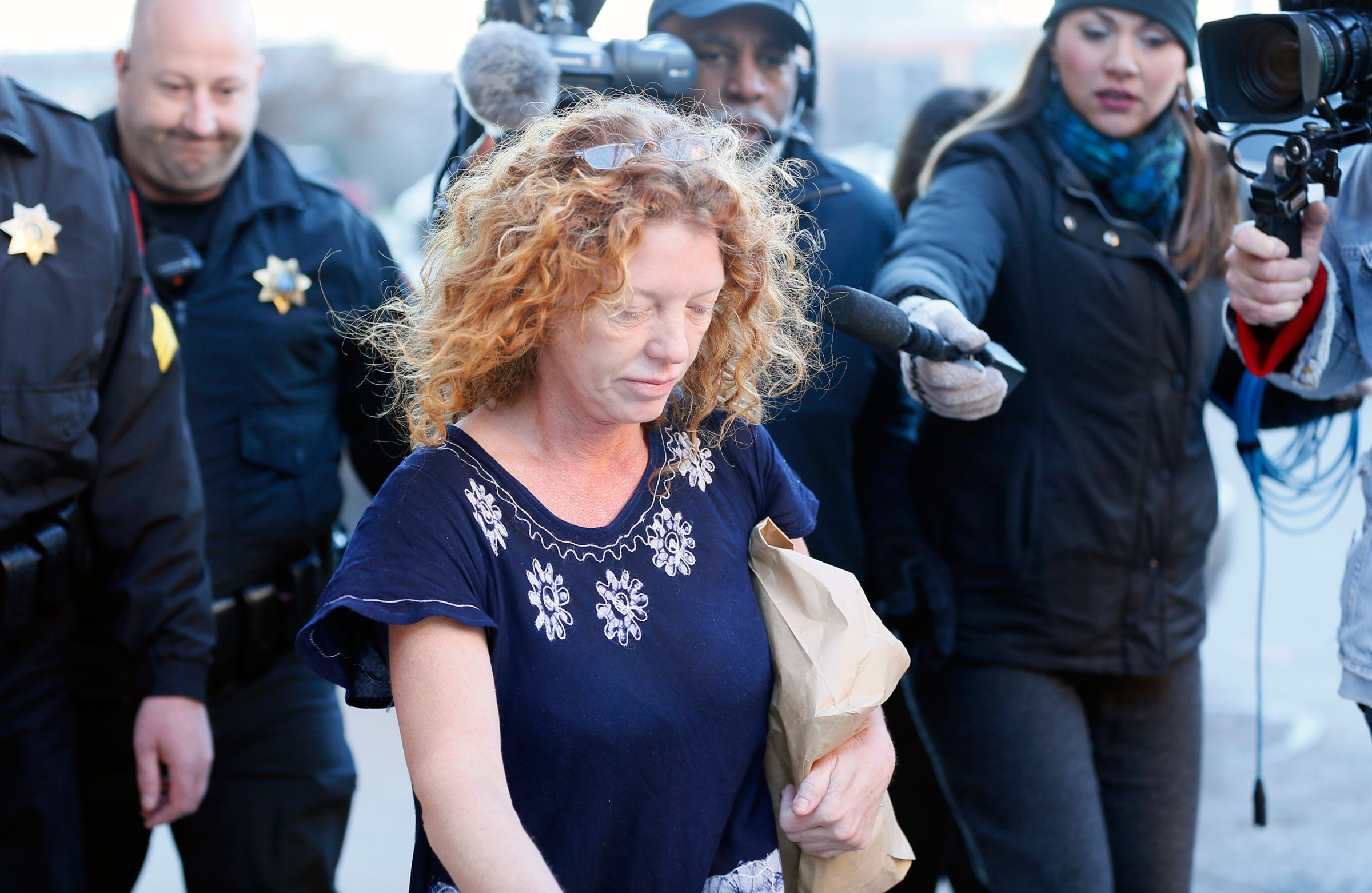 Tonya Couch, center, the mother of a Texas teen who used an "affluenza" defense in a drunken wreck, leaves Tarrant County Jail, Tuesday, Jan. 12, 2016, in Fort Worth, Texas. She is to be fitted with a GPS monitor before release. A judge decreased Couch's bond Monday from $1 million to $75,000. Couch is charged with hindering the apprehension of a felon after she and her son, Ethan Couch, were caught in a Mexican resort city. (AP Photo/Brandon Wade)