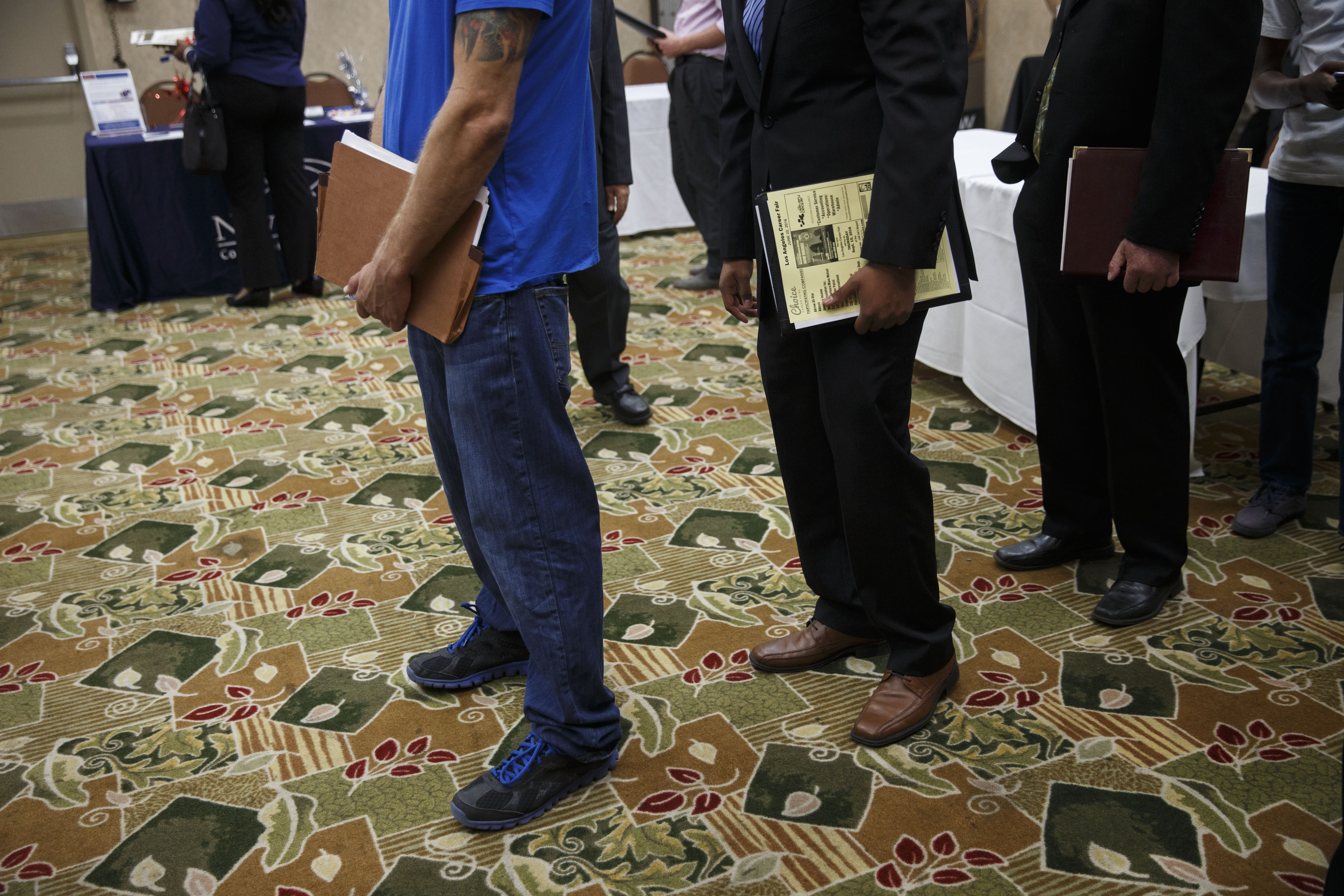 Job seekers wait in line to speak with representatives during a Choice Career Fair in Los Angeles, June 22, 2016. (Patrick T. Fallon—Bloomberg/Getty Images)