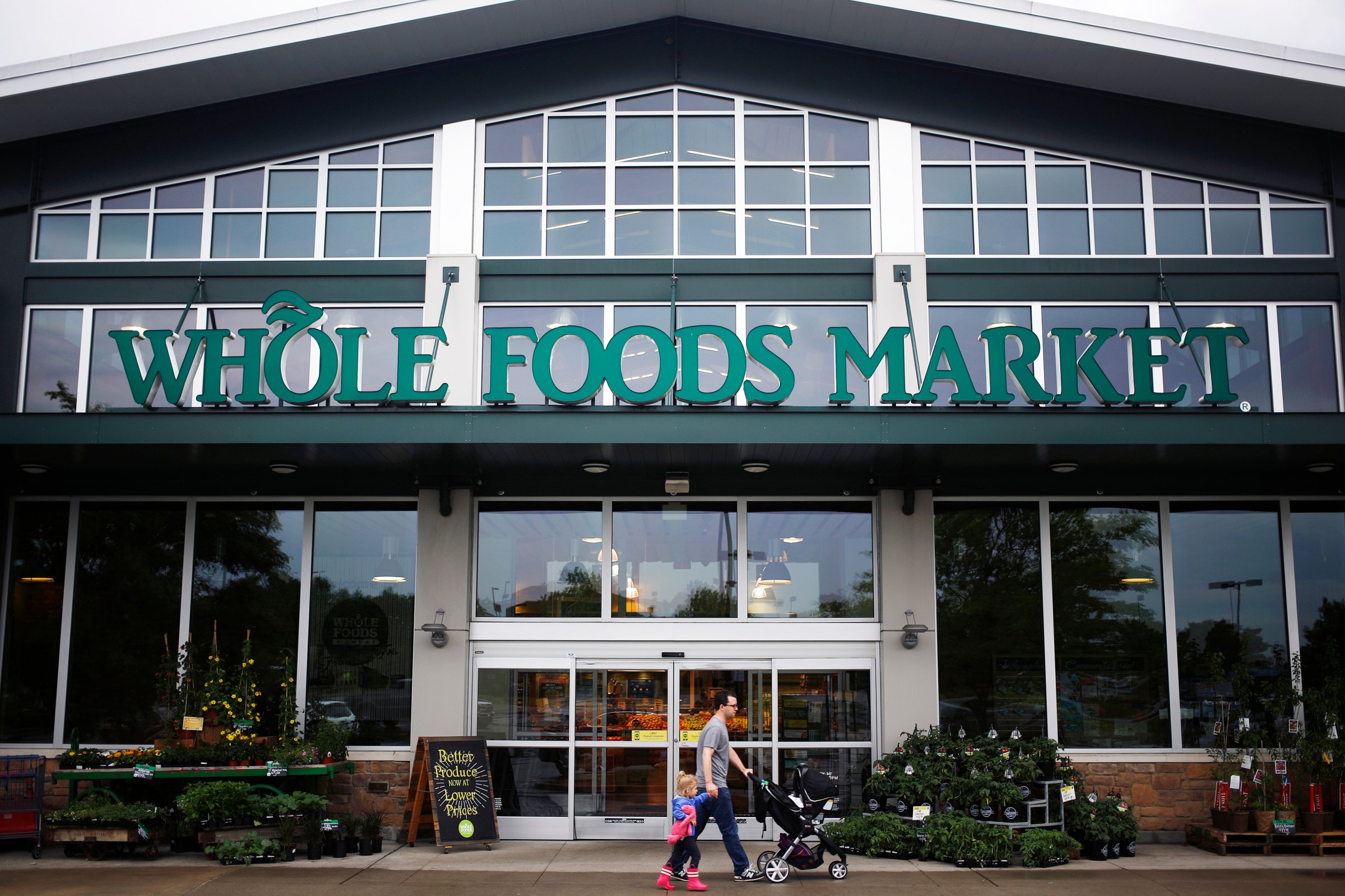 A shopper walks in front of a Whole Foods store in Franklin, Tenn. on April 30, 2016.