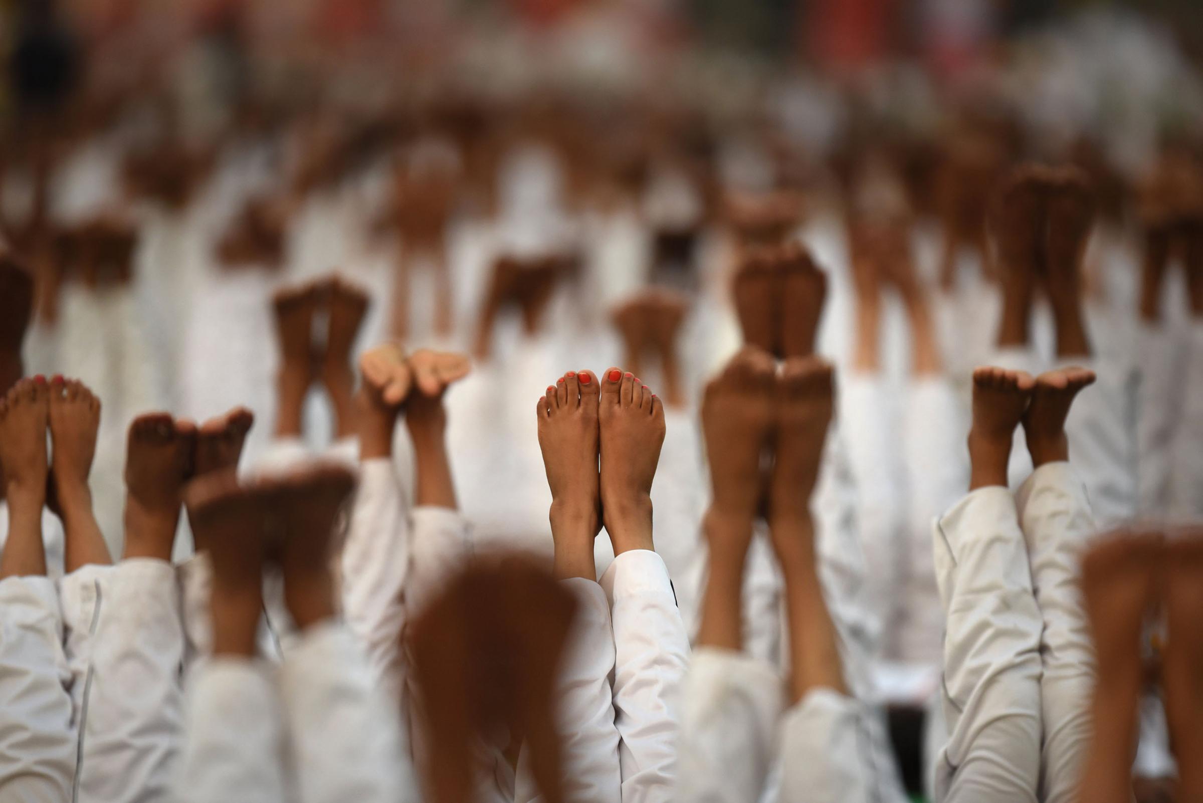 Participants perform Yoga during the rehearsals for the upcoming International Yoga Day at Rajpath in New Delhi, India, on June 19, 2016.