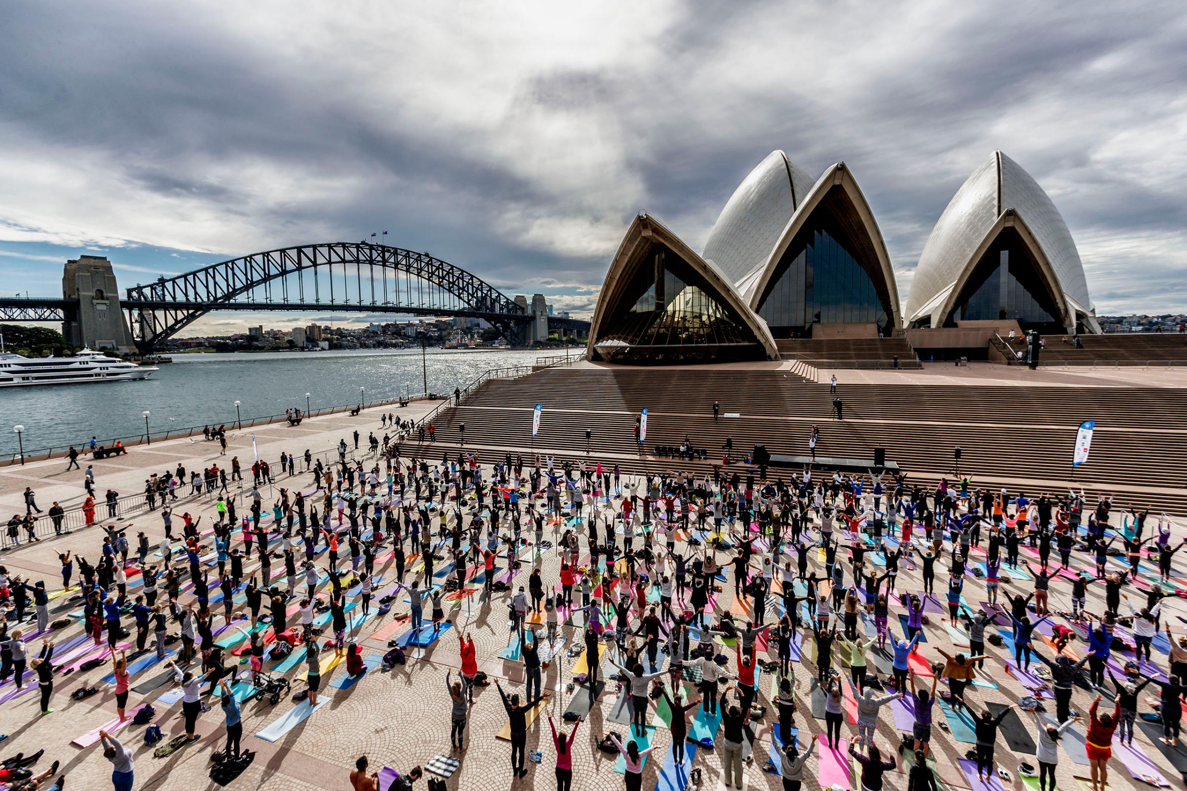 Thousands gather for a group yoga class in front of the Sydney Opera House in Sydney, Australia, on June 21, 2016.