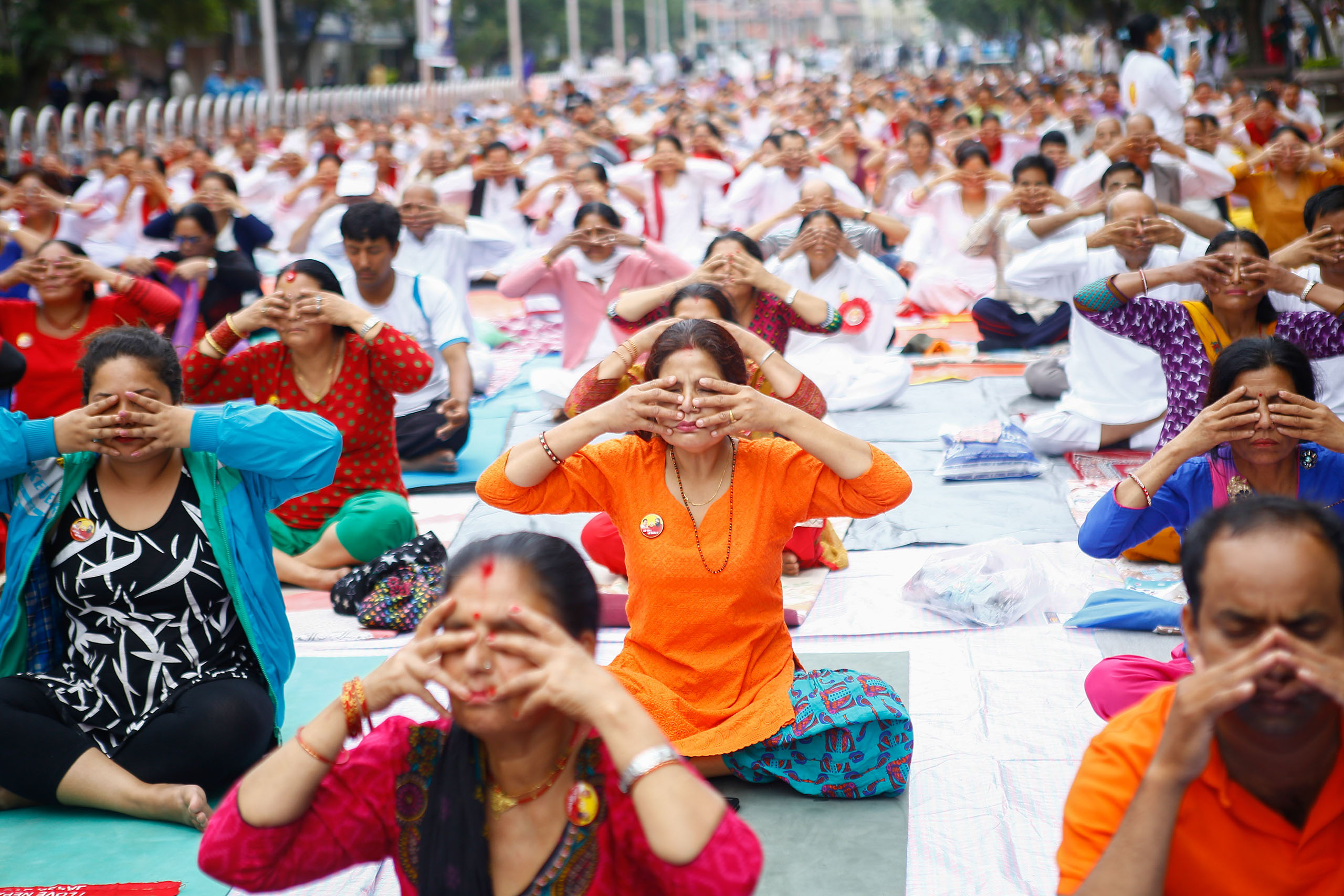 People perform yoga exercises during an event to mark the International Day of Yoga in Kathmandu, Nepal on June 21, 2016.