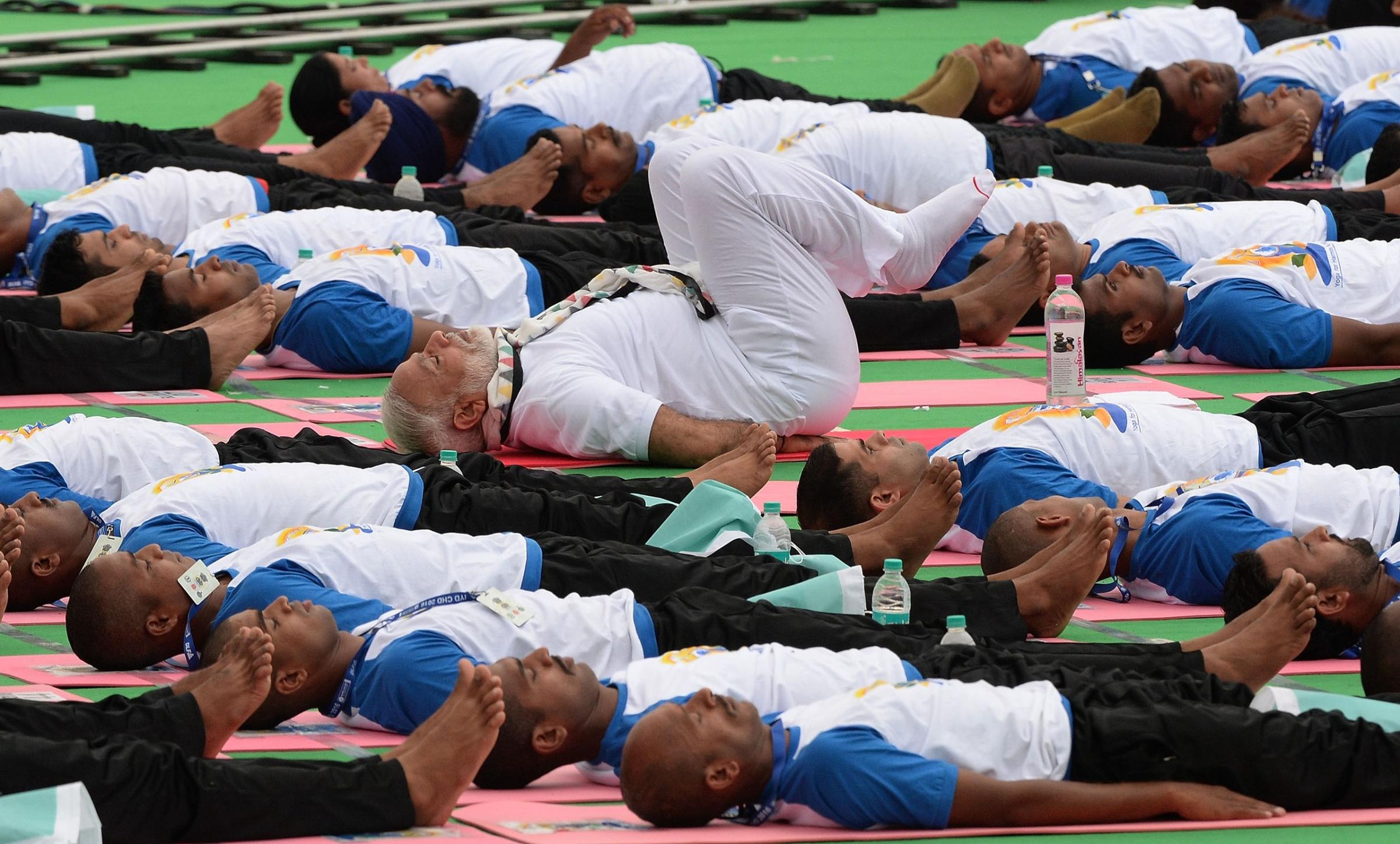 Indian Prime Minister Narendra Modi participates in a mass yoga session along with other Indian yoga practitioners to mark the 2nd International Yoga Day at Captol complex in Chandigarh, India, on June 21, 2016.