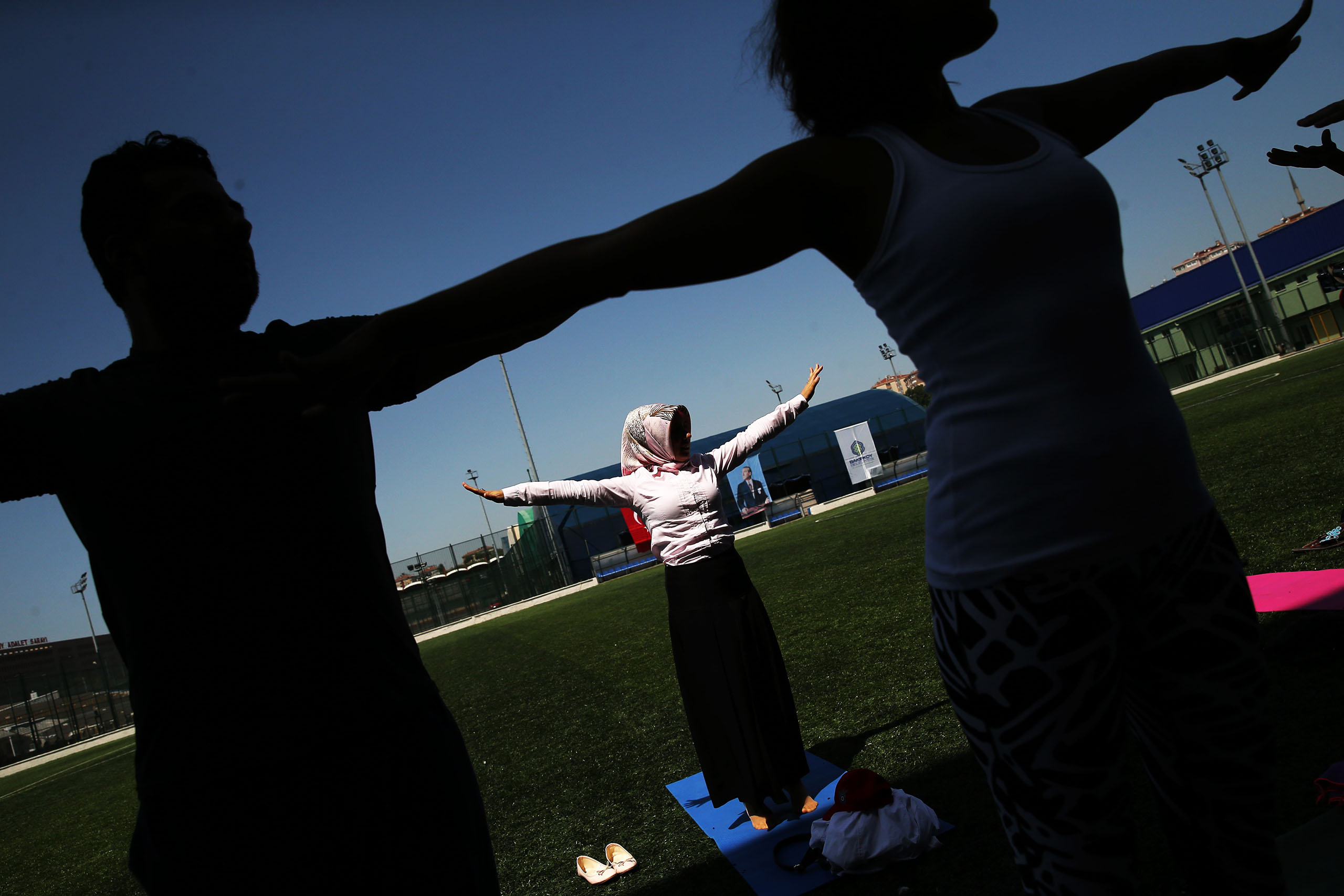 People perform yoga exercises during an event to mark the World Yoga Day 2016 at Bakirkoy Botanik Park in Istanbul, Turkey, on June 21, 2016.