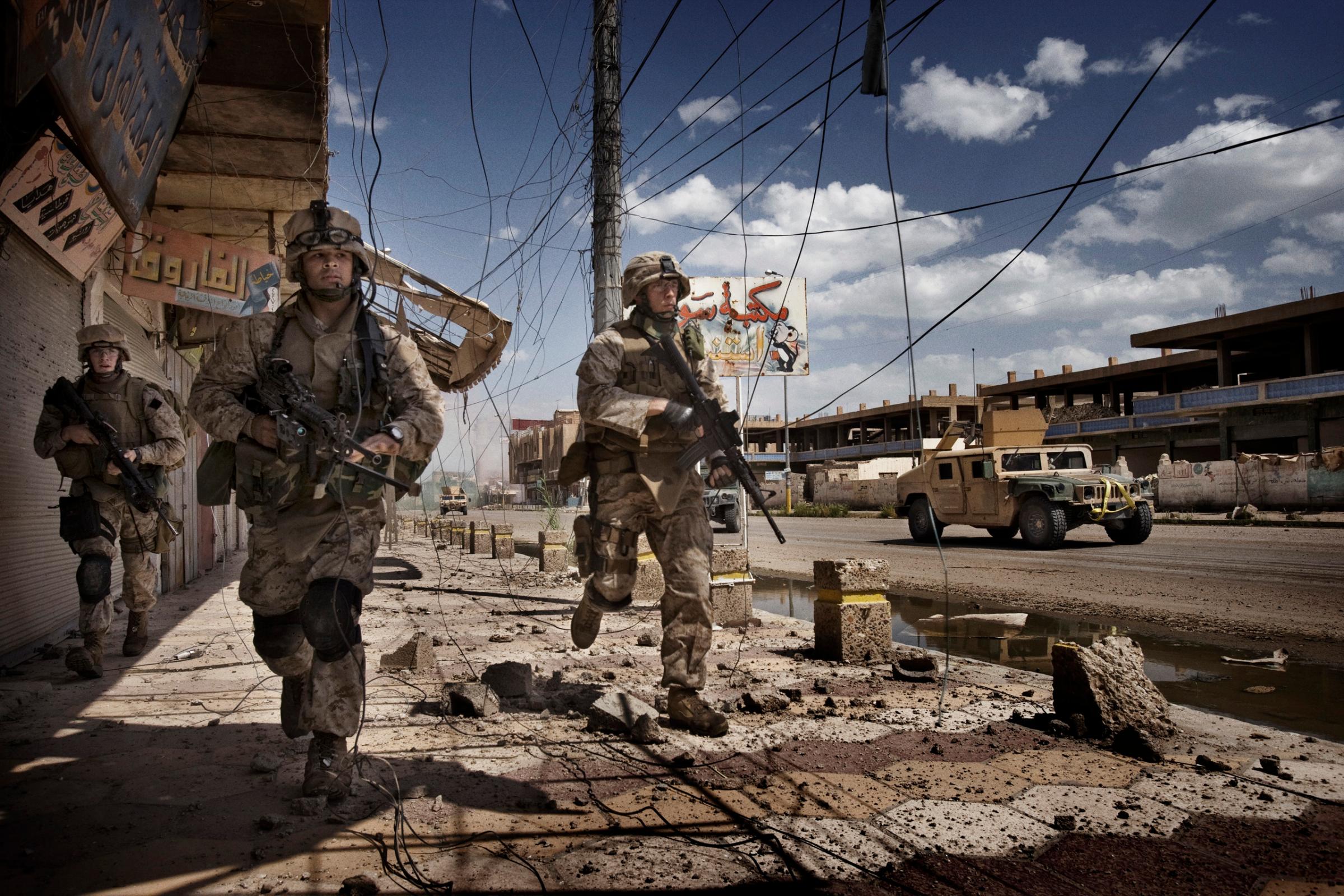 U.S. Marines from the 3rd Battalion, 8th Marine Regiment, Kilo company scan streets and surrounding buildings for insurgents during a patrol in Ramadi, Iraq, April 27, 2006.