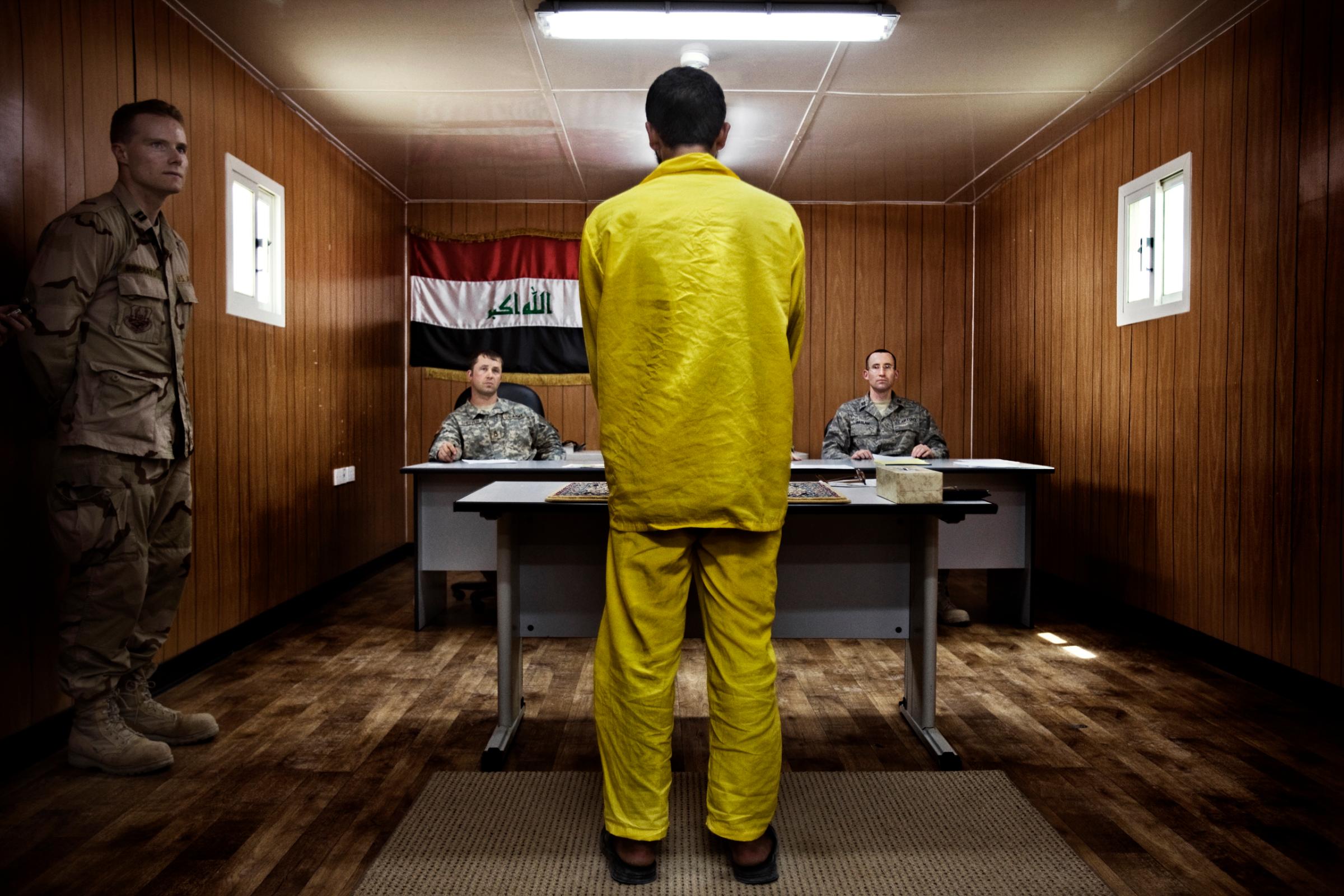 A panel of three American military officers question an Iraqi detainee at Camp Cropper, a U.S. military detention facility in Baghdad, July, 26, 2008. Just under 21,000 Iraqis were held by the U.S. military, outside of the Iraqi justice system, under terms laid out by a U.N. mandate.