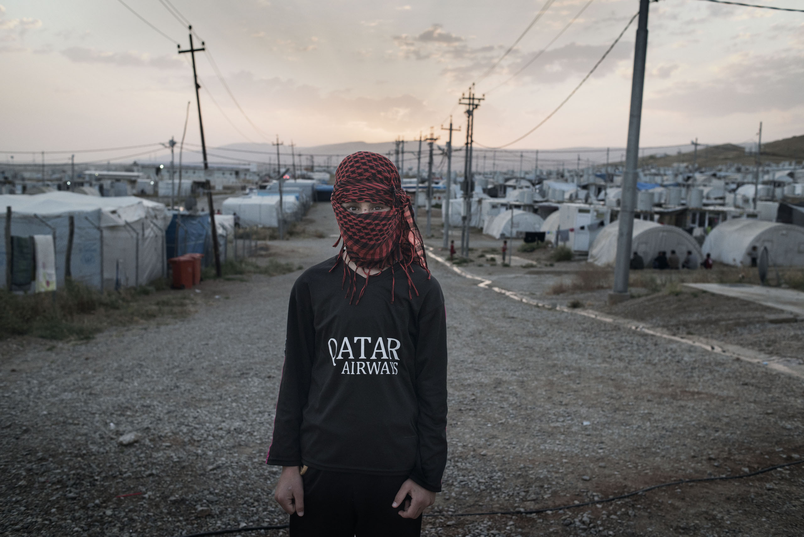 A 16-year old boy at a camp for displaced people outside the city of Dohuk in Iraq's autonomous Kurdish region, May 19, 2016. The teenager was taken captive by ISIS fighters in the summer of 2014 and underwent months of forced military training before escaping in 2015.