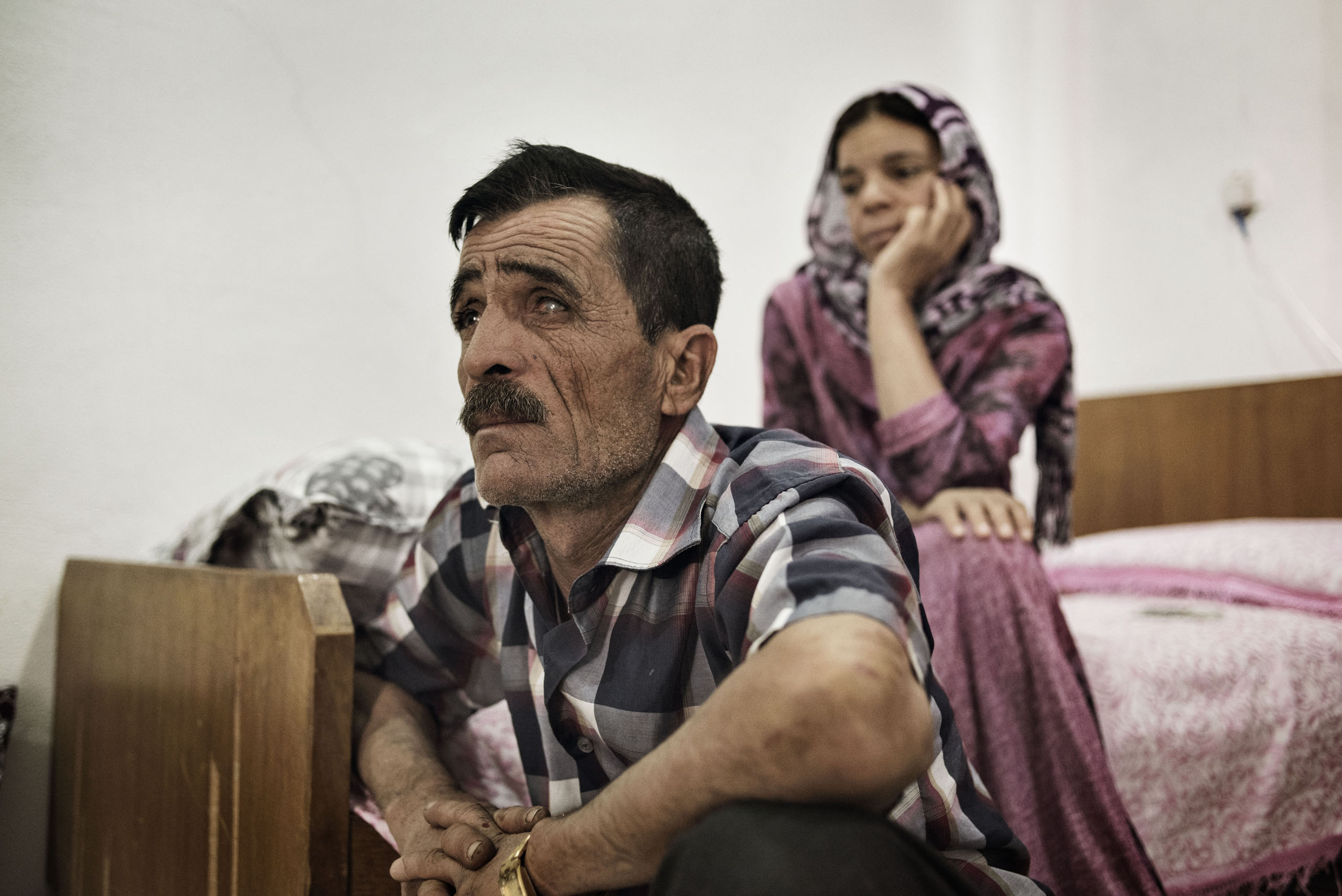 Khero Elias Khalad, 50, sits in an apartment in the Iraqi town of Sinjar,  May 13, 2016. Khalaf fled with his family when ISIS fighters overran the town in Aug. 2014. A shopkeeper, he has returned to live in Sinjar since it was recaptured by Kurdish armed forces in Nov. 2015.