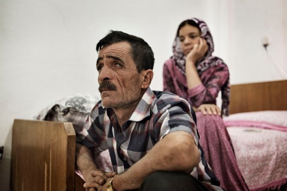 Khero Elias Khalad, 50, sits in an apartment in the Iraqi town of Sinjar, May 13, 2016. Khalaf fled with his family when ISIS fighters overran the town in August 2014. A shopkeeper, he has returned to live in Sinjar since it was recaptured by Kurdish armed forces in November 2015.