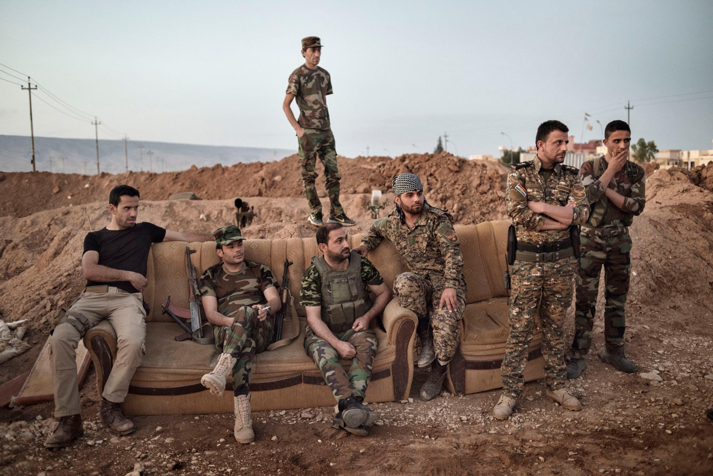 Kurdish fighters take a break while standing guard along the front line against Islamic State forces (ISIS) outside the town of Sinjar, in northern Iraq, May 12, 2016. Reclaimed by Kurdish forces in November 2015, Sinjar is a strategic point between Syria and the ISIS-held city of Mosul.