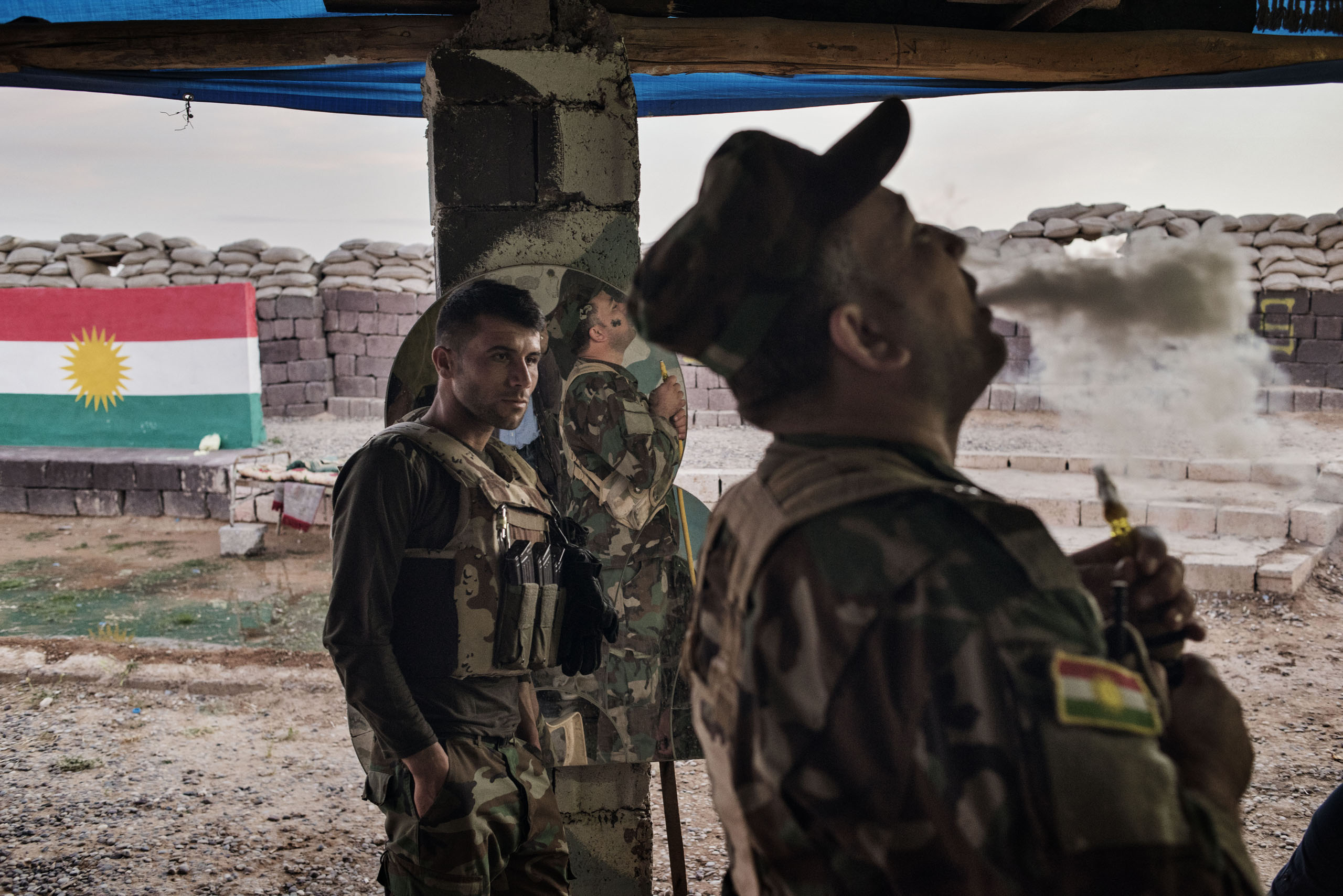 An Iraqi Kurdish fighter exhales tobacco smoke at the front line facing ISIS militants outside the town of Makhmour, northern Iraq, May 8, 2016. Makhmour is one of the key fronts in the battle between Iraqi forces and the jihadists of ISIS. But as a result of disagreements and distrust among rival factions, the overall campaign against ISIS is proceeding slowly. A long-anticipated operation to retake the nearby city of Mosul has been delayed for months.