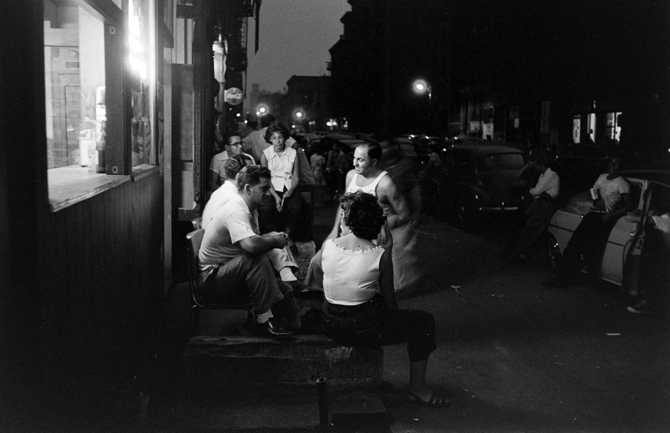 People spending time outdoors during an ongoing heatwave during the summer of 1953 in New York City.