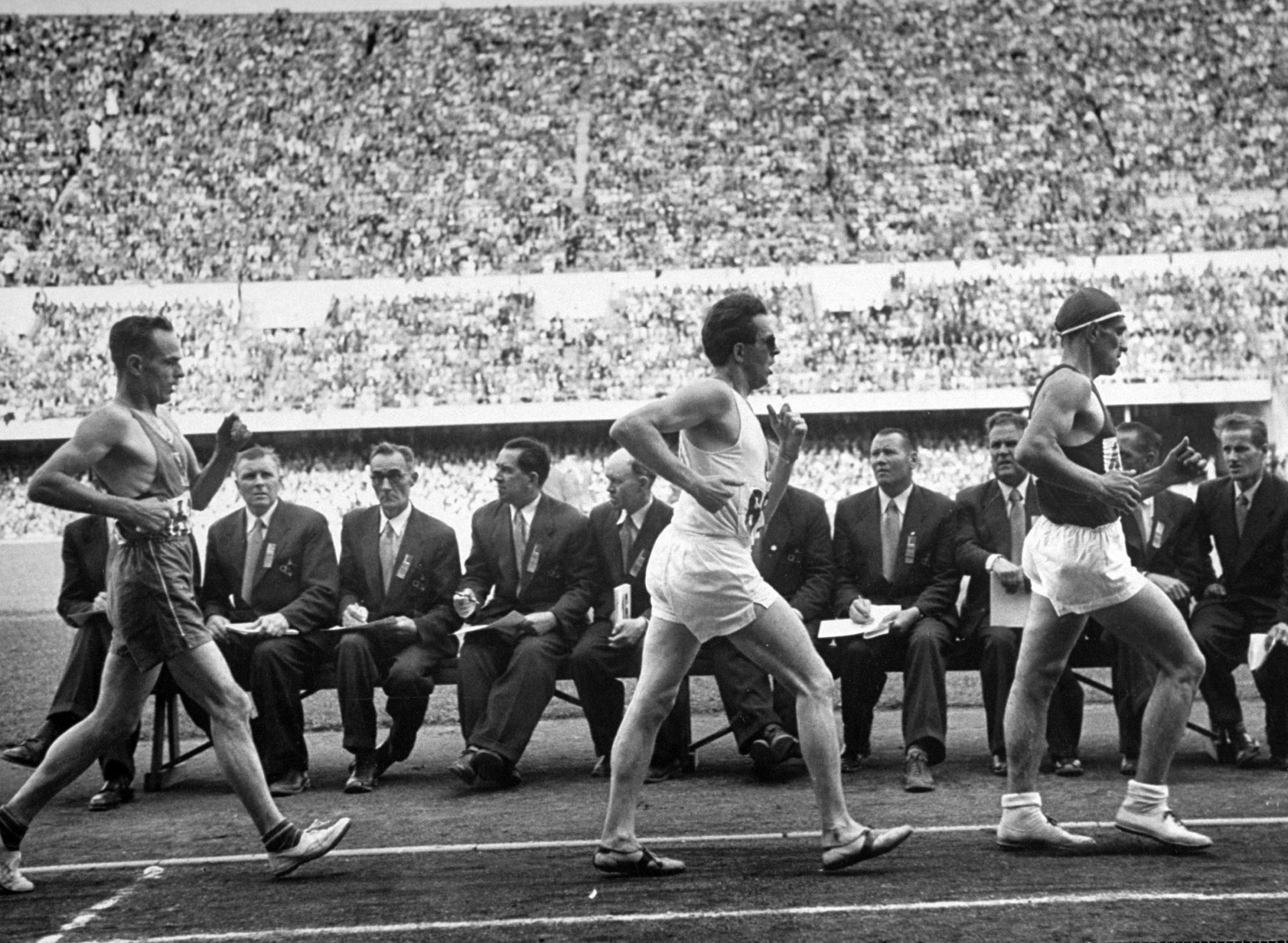 Athletes competing in the 10,000-meter walk at the 1952 summer Olympics in Helsinki, Finland.