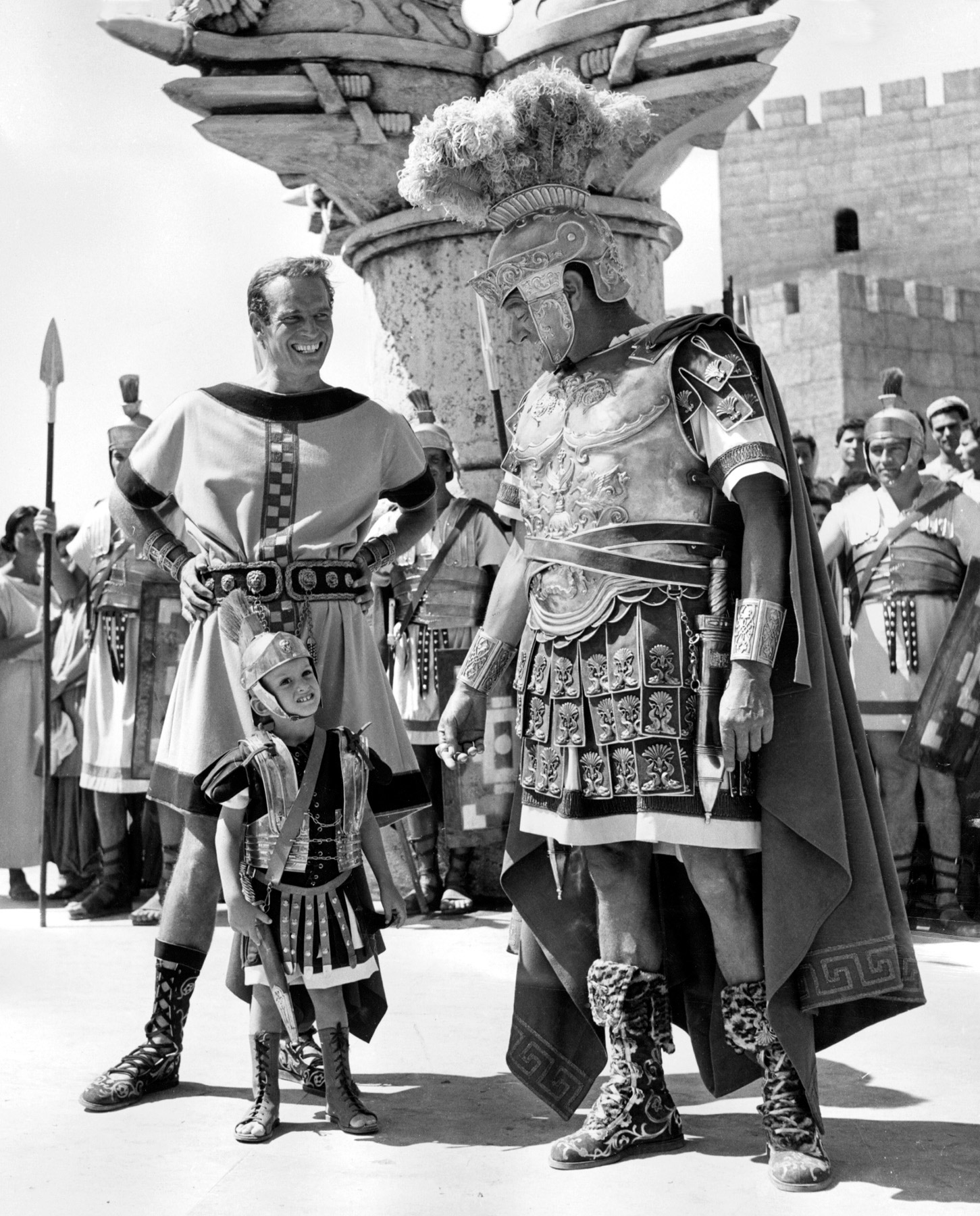 Charleton Heston on the set of Ben-Hur in Rome with his three-year old son Fraser (center).  and co-star Jack Hawkins.