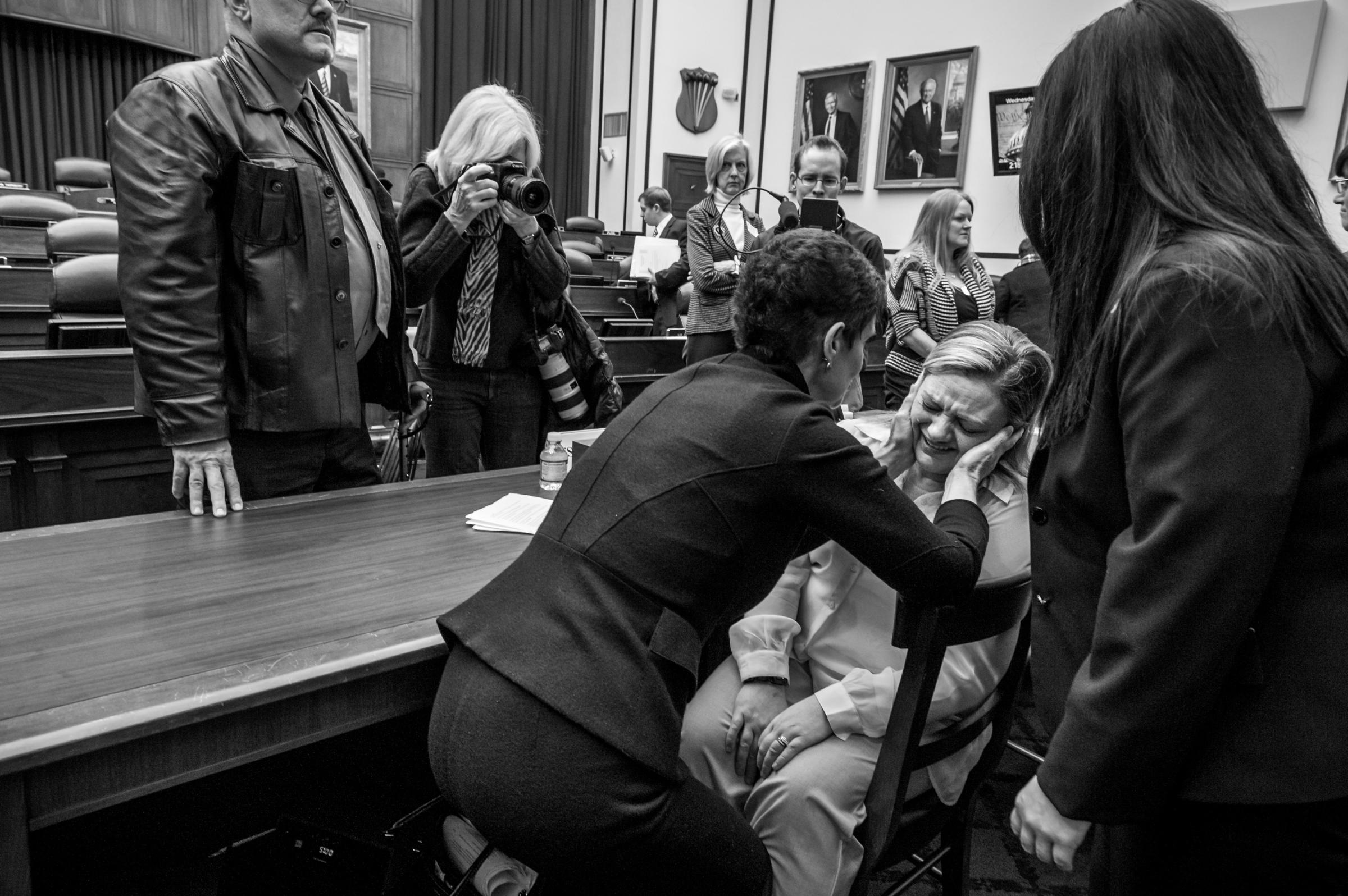 TSgt Jennifer Norris is comforted by Nancy Parrish, President, Protect Our Defenders, after testifying before the sparsely attended House Armed Services Committee hearing on Capitol Hill, to discuss sexual misconduct by basic training instructors at Lackland Air Force Base in San Antonio, Texas.