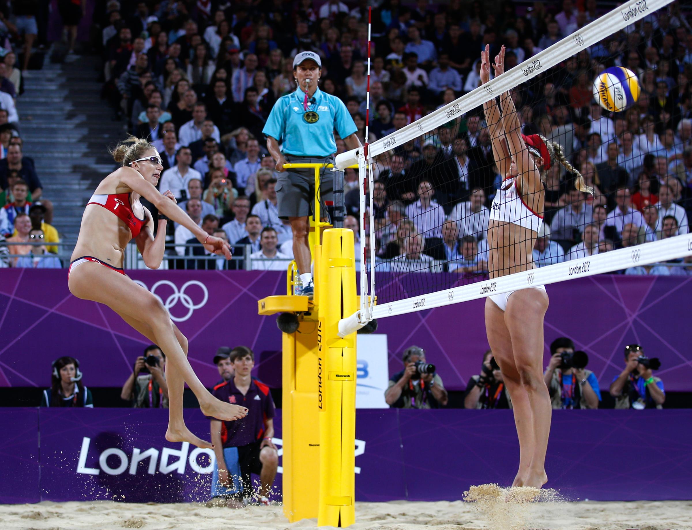 Kerri Walsh Jennings of the U.S. spikes the ball past April Ross of the U.S. at the women's beach volleyball gold medal match at the Horse Guards Parade