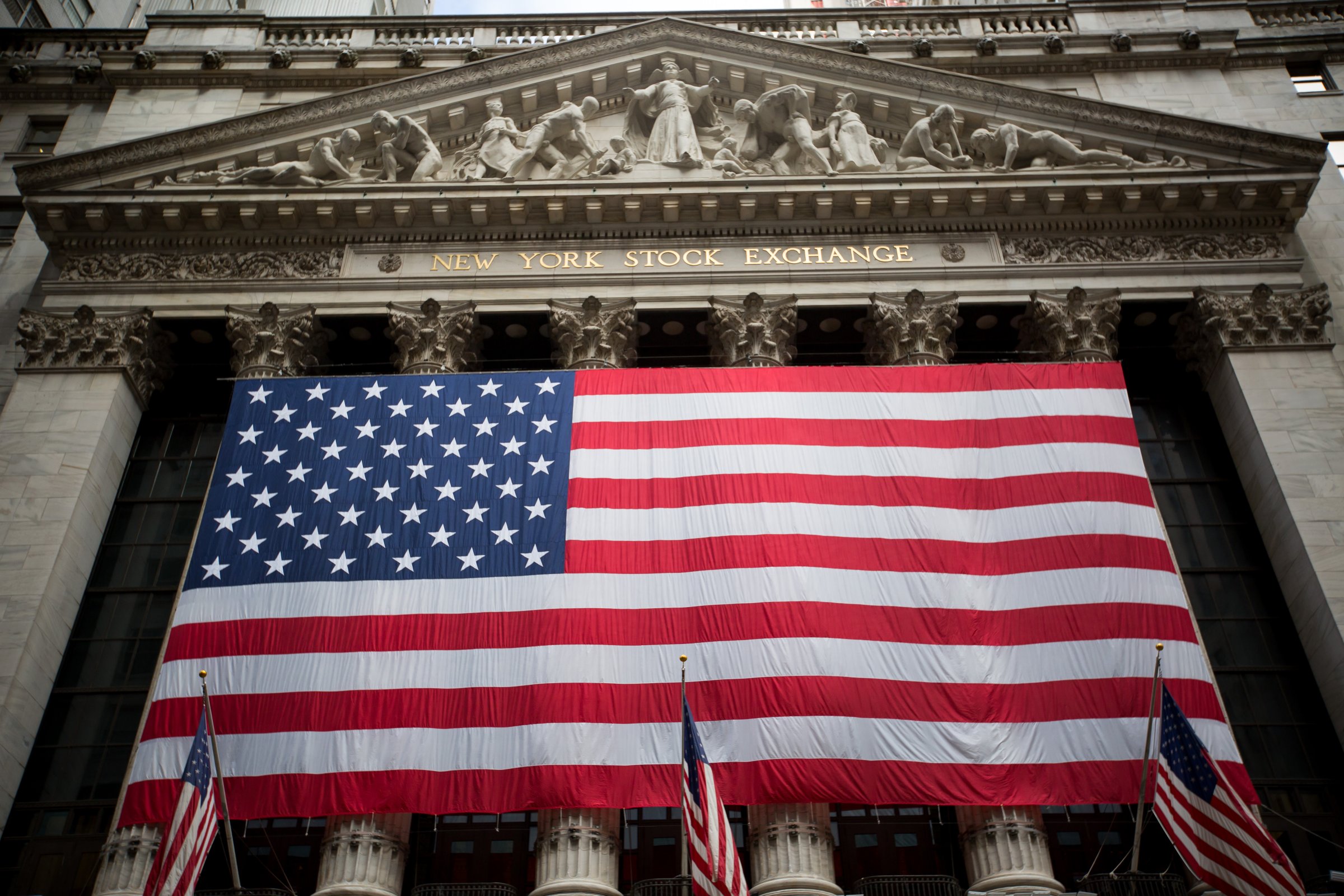 An American flag is displayed outside the New York Stock Exchange (NYSE) stands in New York, U.S., on Tuesday, July 5, 2016.