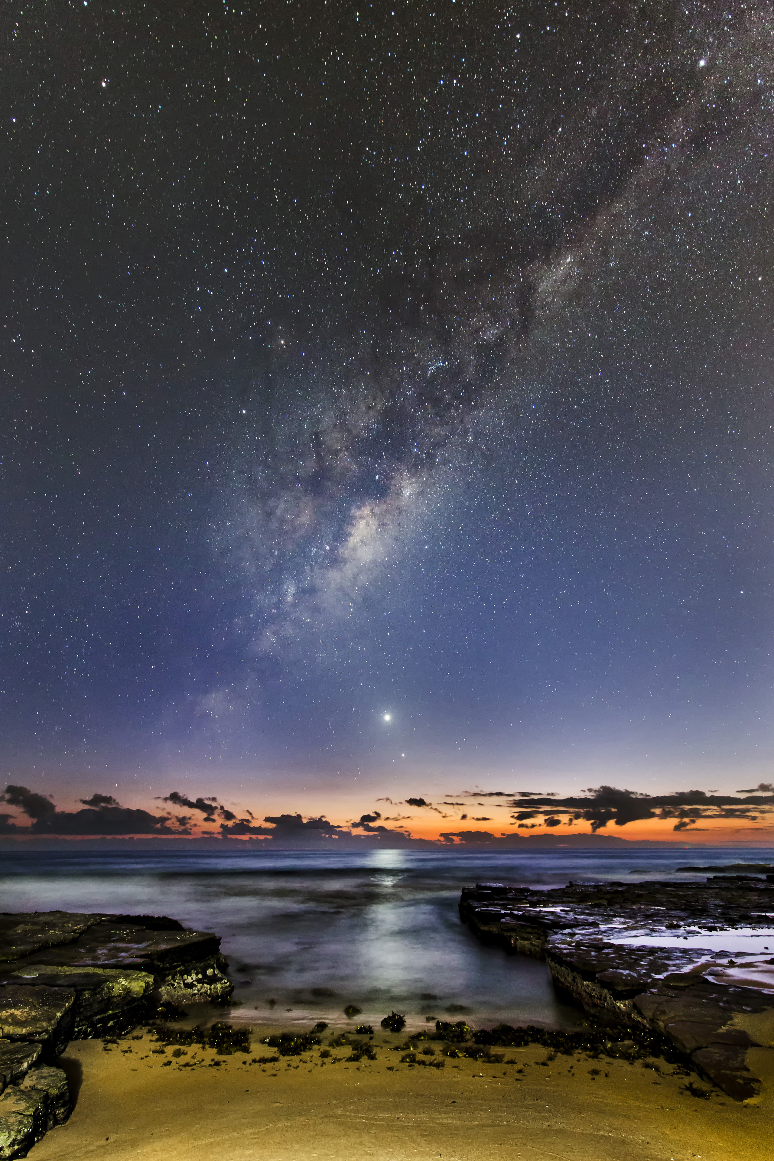 During the seldom-seen alignment of the five planets in Feb. 2016, Venus, Mercury and the Milky Way rose an hour before sunrise, and appear to be fleeing its early glow, overlooking Turrimeta Beach, Australia.