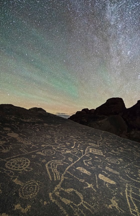 Ancient petroglyphs are lit up by the glittering stars of the night sky in the Eastern Sierras in Calif.