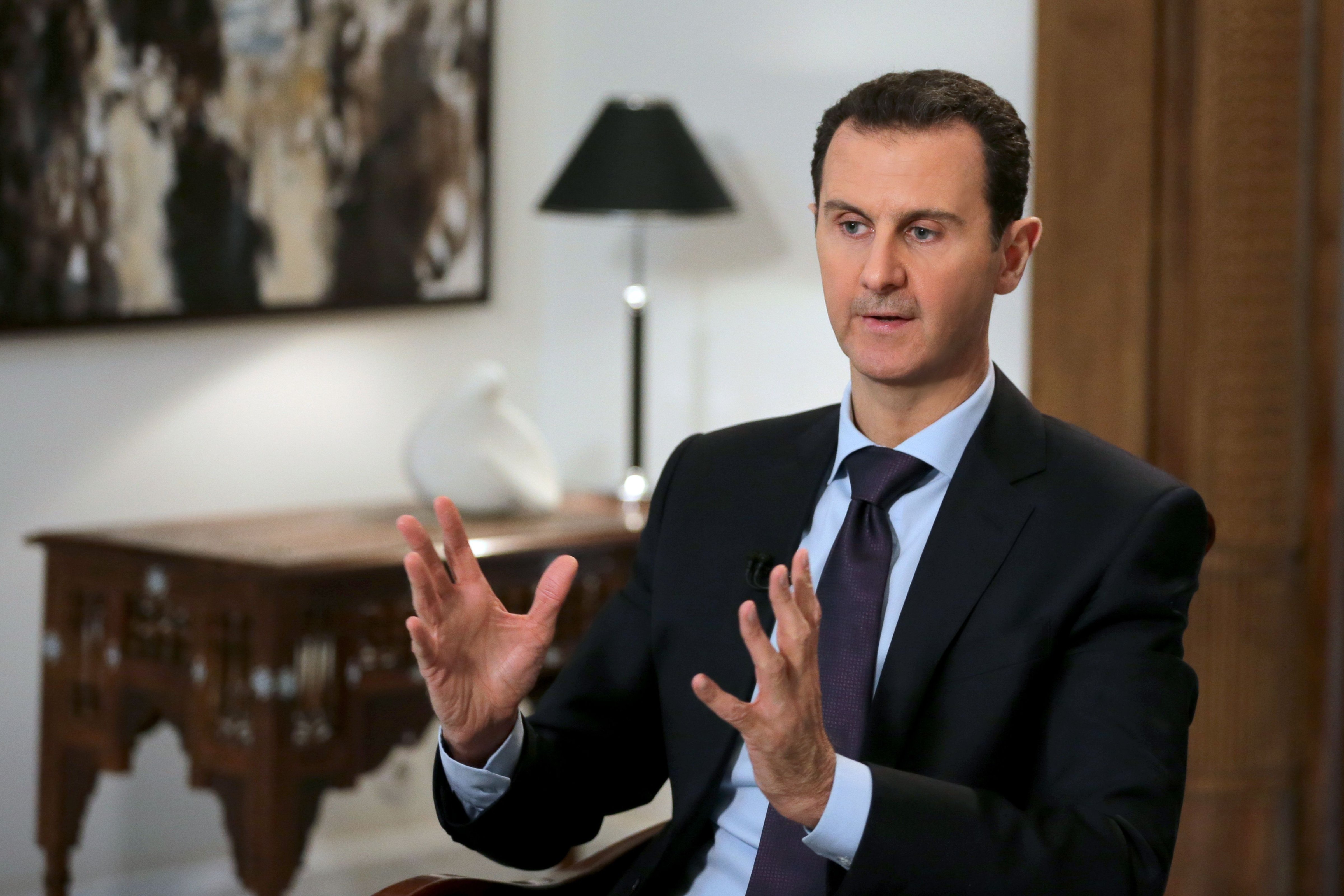 Syrian President Bashar al-Assad gestures during an exclusive interview with AFP in the capital Damascus on Feb. 11, 2016. (Joseph Eid—AFP/Getty Images)