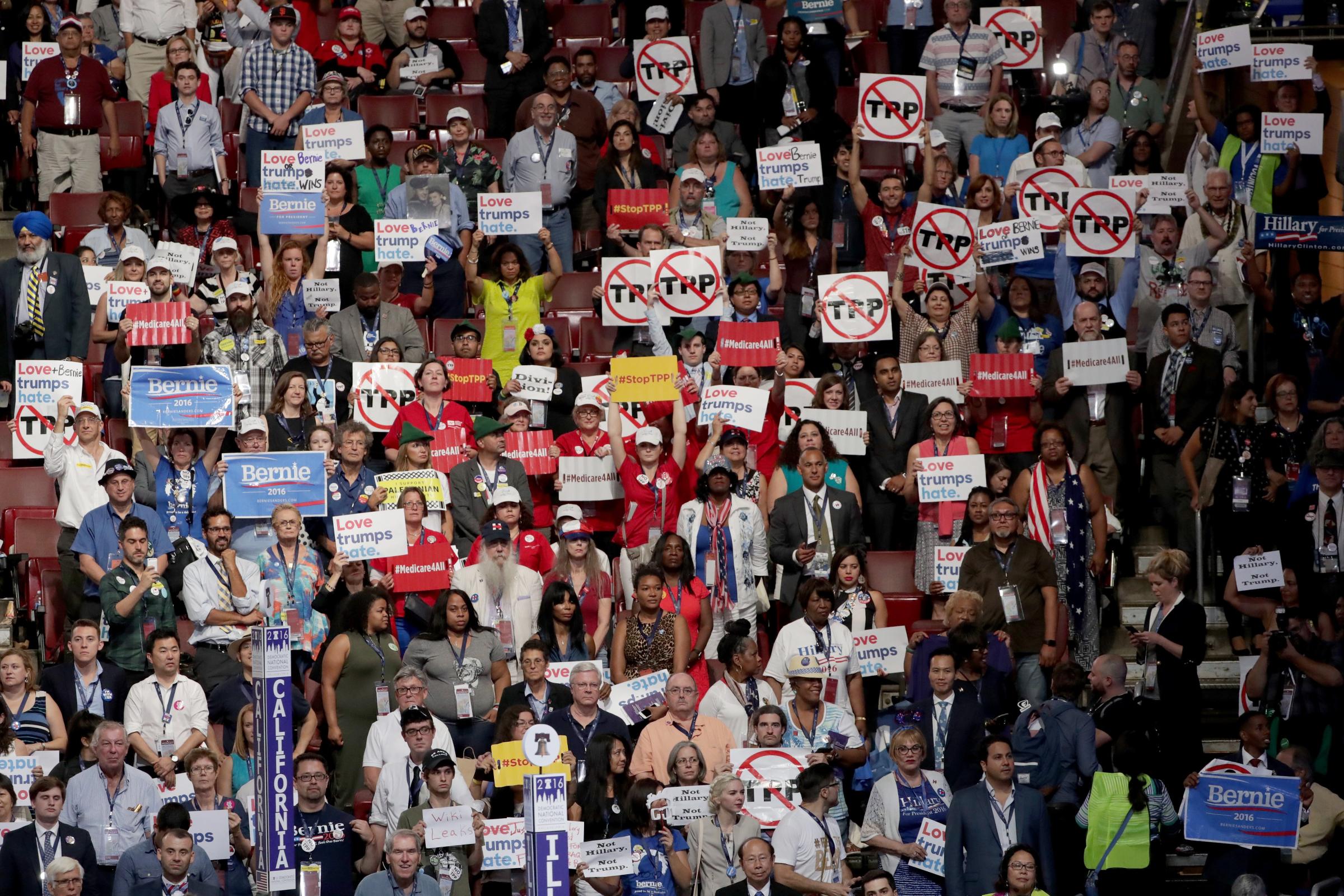 Delegates and attendees in support of Sen. Bernie Sanders (I-VT) hold up signs on the first day of the Democratic National Convention at the Wells Fargo Center, July 25, 2016 in Philadelphia.