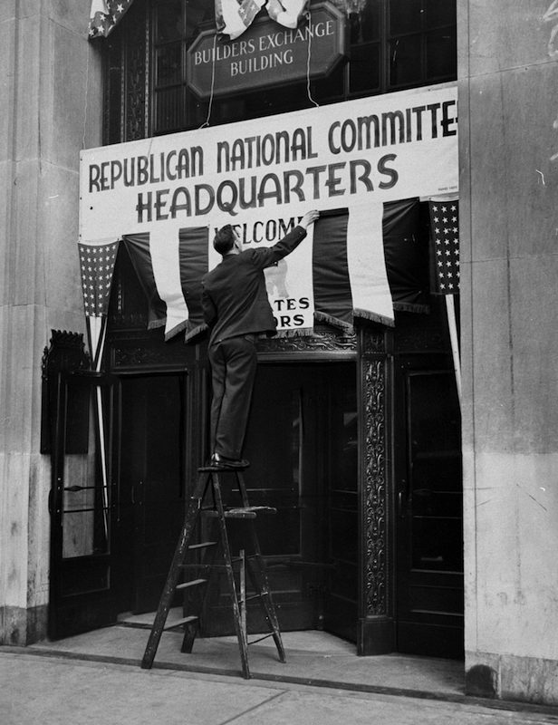 Worker puts up sign for the Republican National Convention C