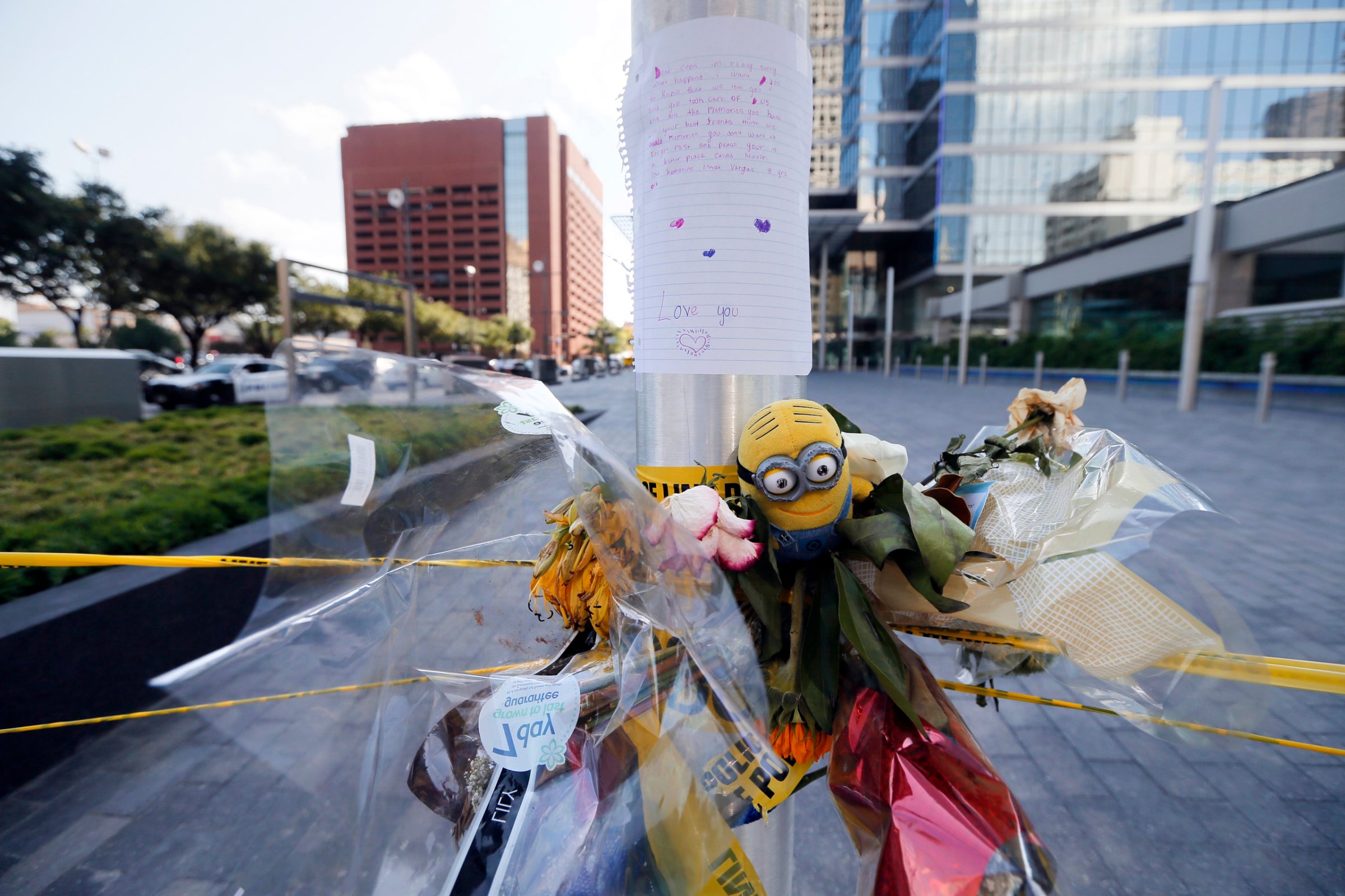 A letter from a child to Dallas police officers sits atop flowers and other items left at a makeshift memorial by the crime scene of Thursday night's shooting in Dallas on July 10, 2016.